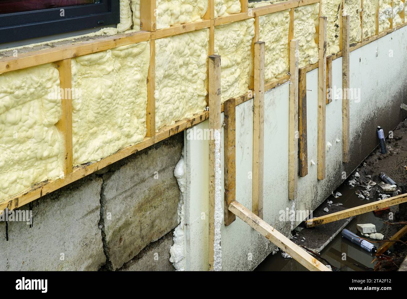 Thermal insulation of the concrete foundation of the residential house with foam boards, facade