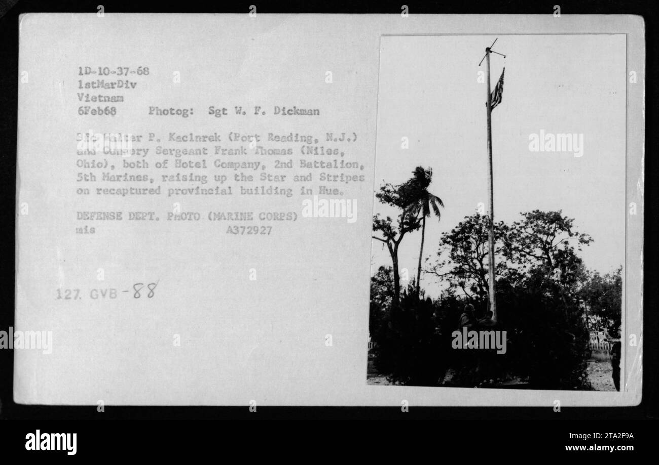 Sgt W. F. Dickman's photograph shows Pfc Walter P. Kecinrek and Gunnery Sergeant Frank Thomas from Hotel Company, 2nd Battalion, 5th Marines, hoisting the American flag on a provincial building they recaptured in Hue on February 6, 1968. This image encapsulates the combat activities carried out by American military personnel during the Vietnam War. Stock Photo