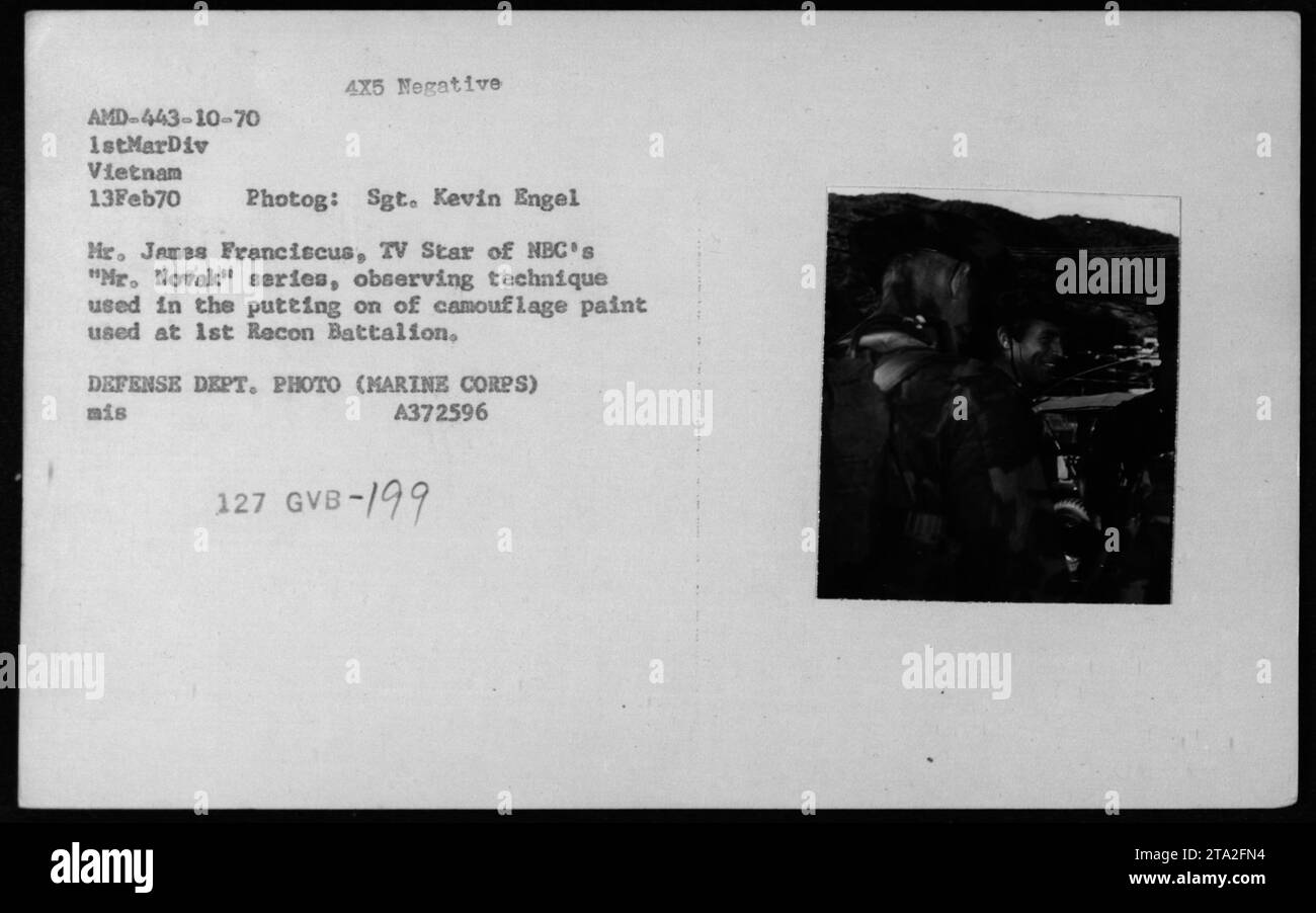 Actor James Franciscus, star of NBC's 'Mr. Novak,' observes the technique used to apply camouflage paint at the 1st Recon Battalion during his visit to Vietnam on February 13, 1970. This photograph was taken by Sgt. Kevin Engel and is part of the Defense Department's photographic documentation of American military activities during the Vietnam War. Stock Photo