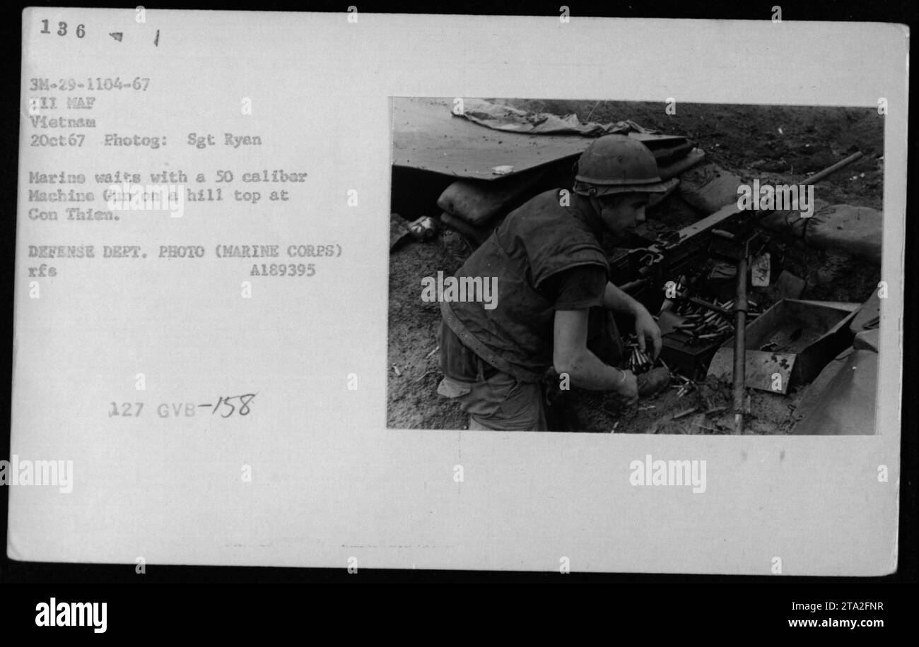 A marine soldier waits on a hilltop at Con Chim during the Vietnam War ...