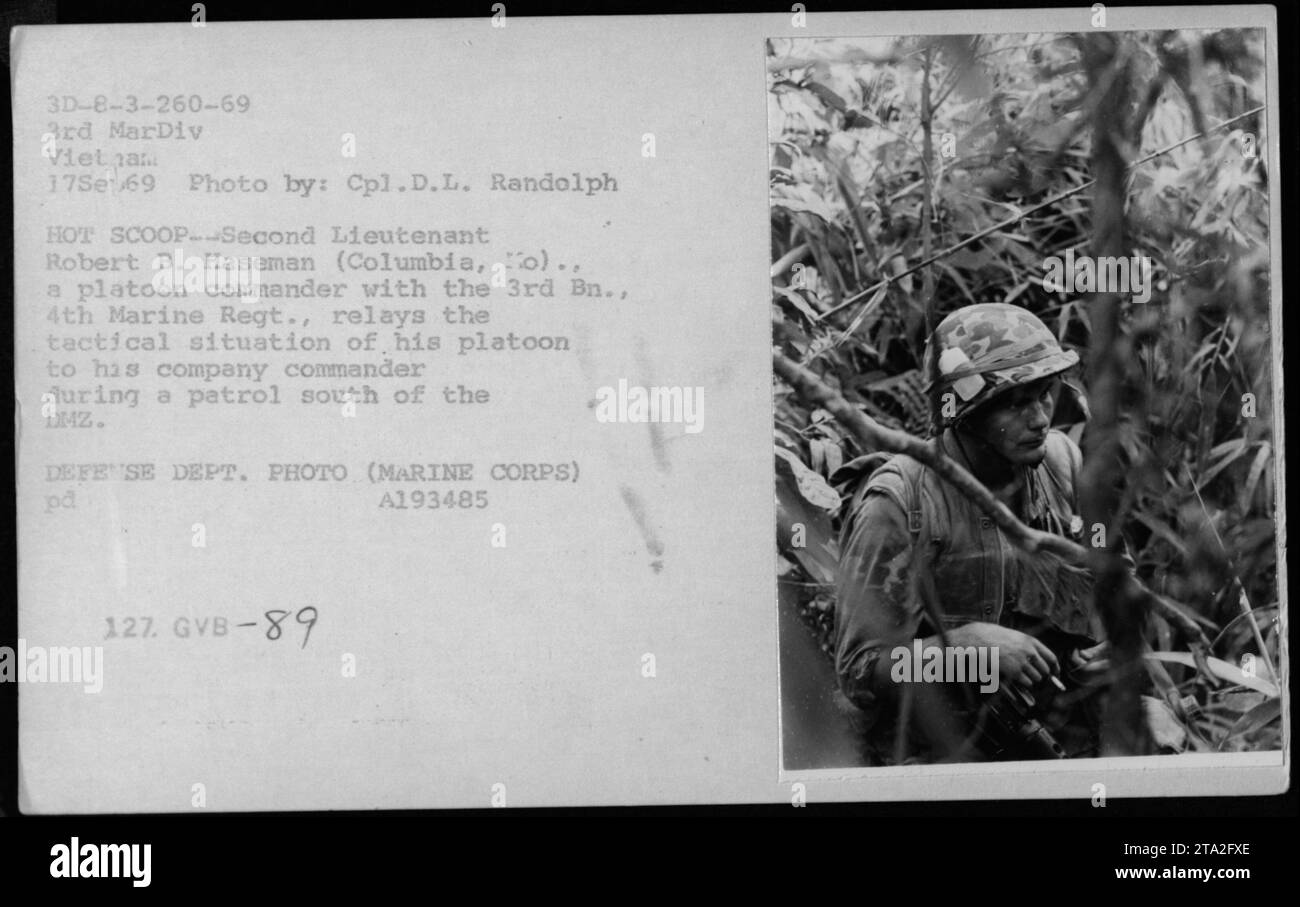 Second Lieutenant Robert B. Haseman, a platoon commander with the 3rd Battalion, 4th Marine Regiment, relays the tactical situation of his platoon to his company commander during a patrol south of the Demilitarized Zone (DMZ) in Vietnam. This photograph was taken on September 17, 1969, by Cpl.D.L. Randolph. It captures an authentic moment from combat during the Vietnam War. Stock Photo