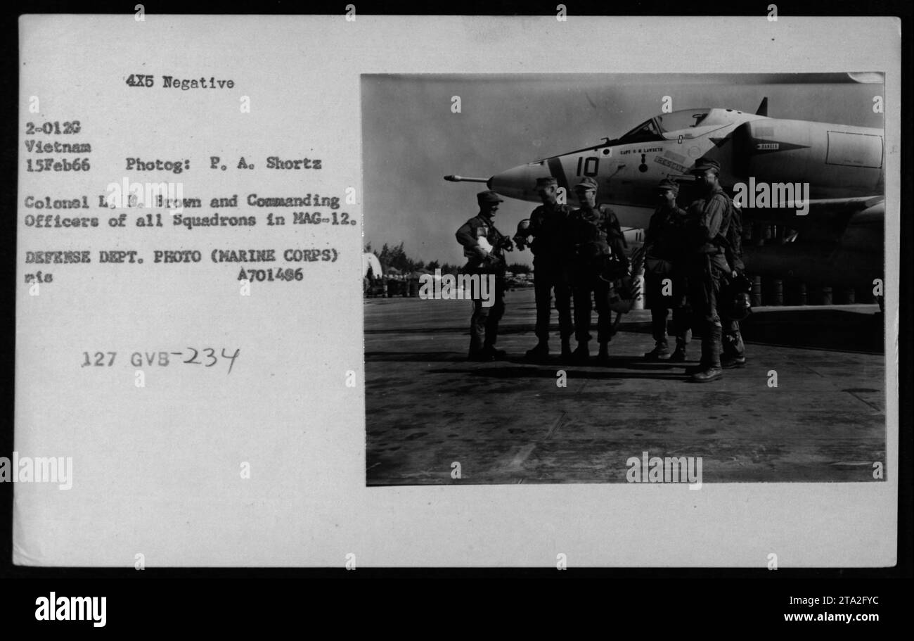 Colonel L.E. Brown and Commanding Officers of all Squadrons in MAG-12 meet legendary pilot Gregory 'Pappy' Boyington during his visit to their old squadron on February 15, 1966. This photograph captures a historic moment during the Vietnam War. (Factual caption). Stock Photo