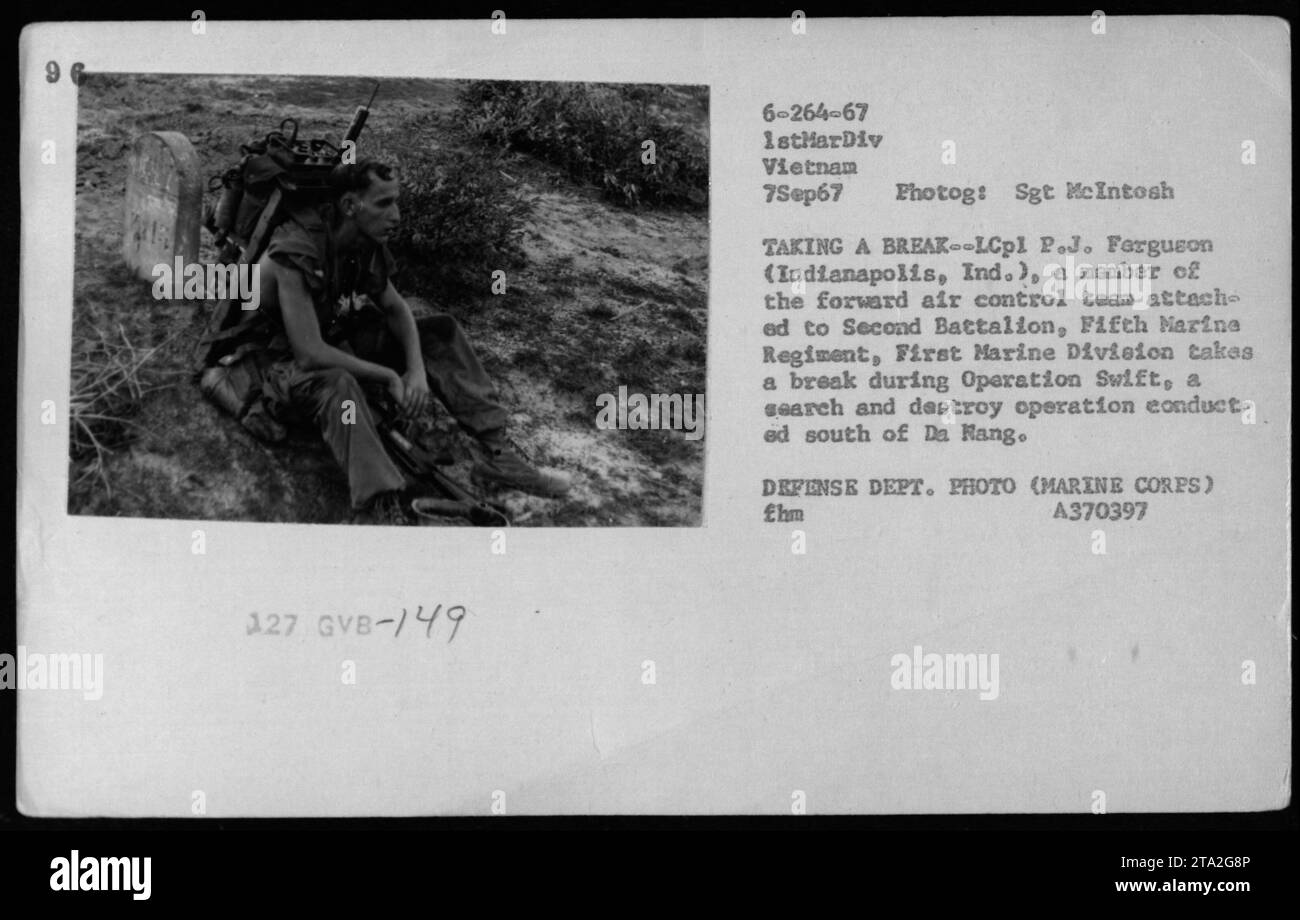 LCpl P.J. Ferguson of Indianapolis, Indiana, a member of the forward air control team attached to the 2nd Battalion, 5th Marine Regiment, 1st Marine Division, takes a break during Operation Swift. This operation was a search and destroy mission conducted south of Da Nang, Vietnam on September 7, 1967. The photograph was taken by Sgt. McIntosh of the Marine Corps. DEFENSE DEPT. PHOTO (MARINE CORPS) Stock Photo