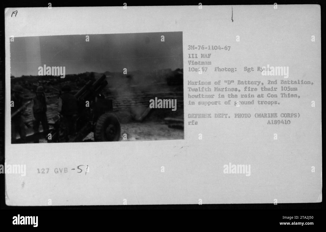 'Marines from 'D' Battery, 2nd Battalion, Twelfth Marines, fire a 105mm howitzer in the rain at Con Thien on October 1, 1967. The artillery support was provided to ground troops from III Marine Amphibious Force. This photograph was taken by Sgt Ryan Harines. Defense Department photo (Harine Corps).' Stock Photo