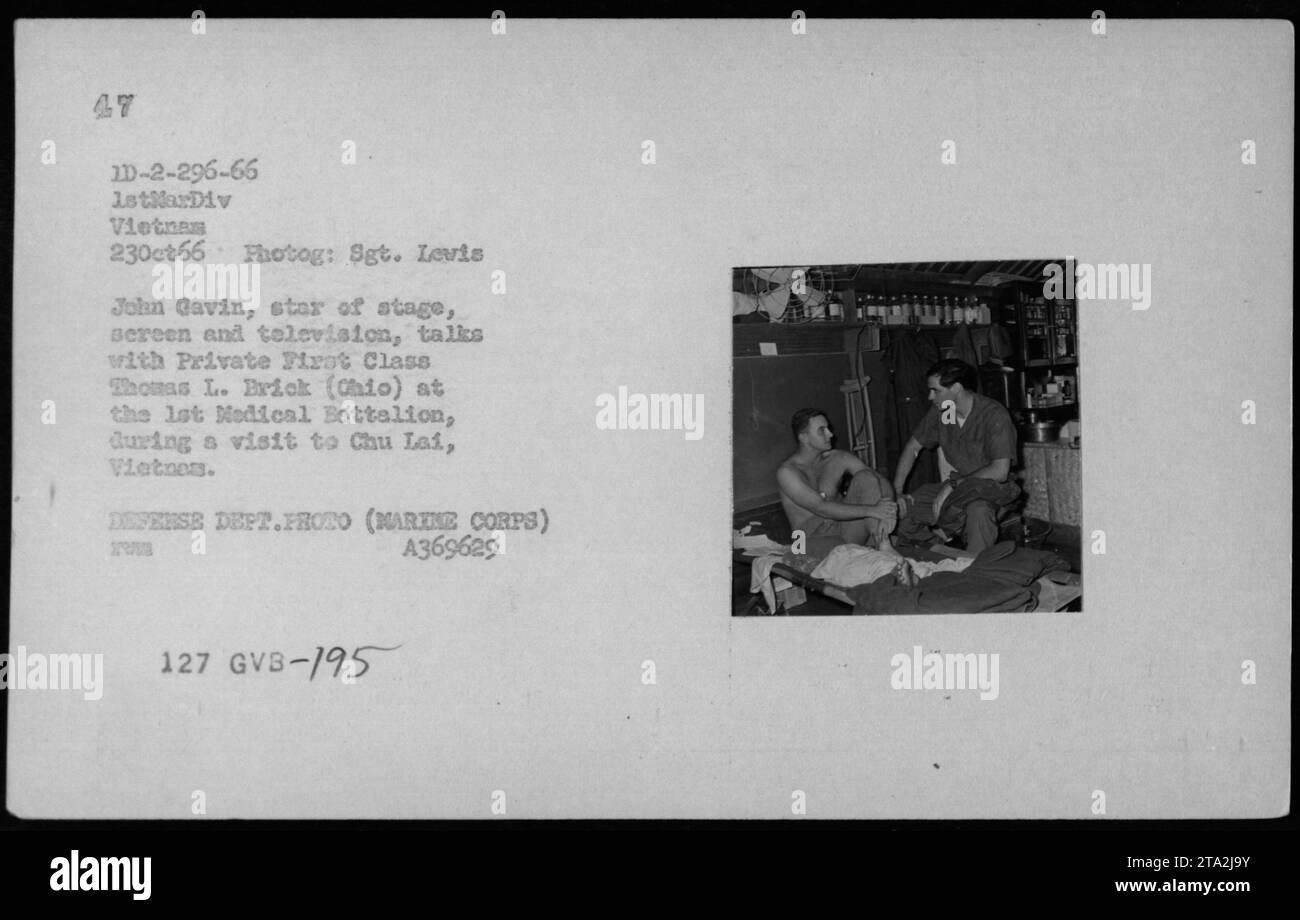 John Gavin, a famous actor, engages in conversation with Private First Class Thomas L. Brick at the 1st Medical Battalion in Chu Lai, Vietnam. Taken on October 23, 1966, this photograph captures the visit of an entertainer to American military personnel during the Vietnam War. Stock Photo