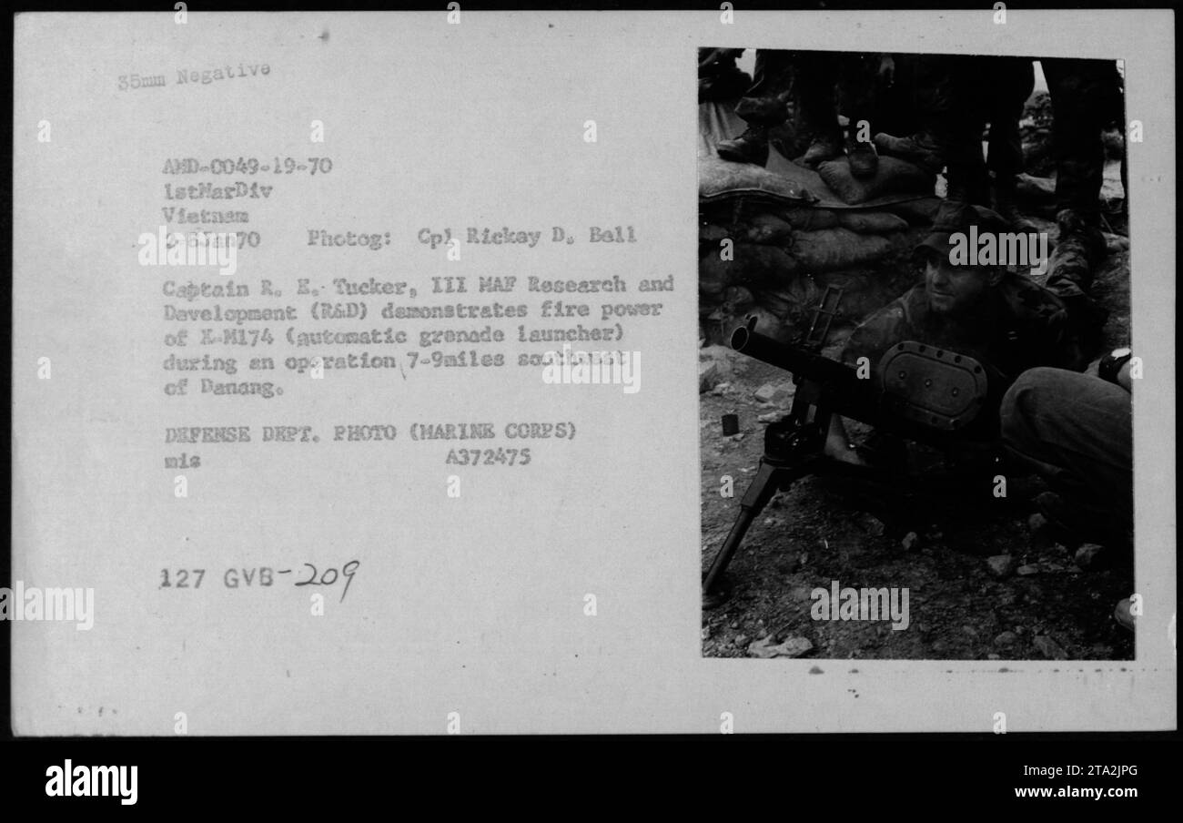 Capturing the firepower of the X-M174 automatic grenade launcher, Captain R. E. Tucker, III from MAF Research and Development (R&D) conducted a demonstration during a military operation 7-9 miles southwest of Danang. The photograph, taken by Cpl Rickay D. Ball on January 2, 1970, shows the intense engagement of the 1stMarDiv in Vietnam. Stock Photo