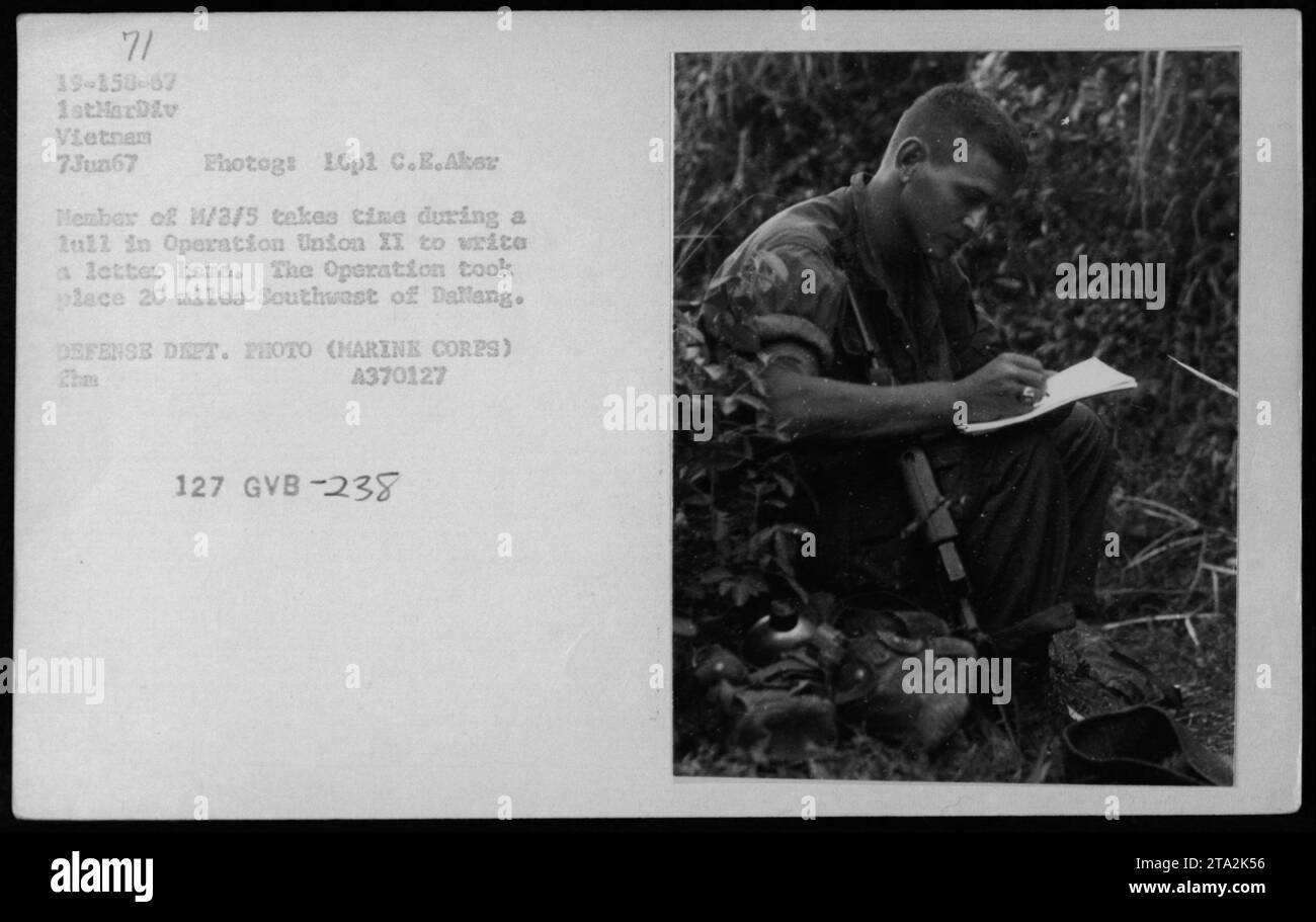 Marine Cpl. C.E. Aker, a member of M/3/5, takes a break during Operation Union II to write a letter home. The operation occurred approximately 20 miles Southwest of Dallang, Vietnam. This photograph was taken on June 7, 1967, by the Defense Department and is part of the Marine Corps archives. Stock Photo