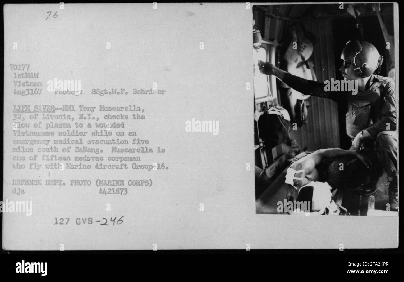 'HM1 Tony Muscarella provides medical aid to a wounded Vietnamese soldier during an emergency medical evacuation. Muscarella, a Navy corpsman from Livonia, N.Y., is part of a team of fifteen corpsmen who fly with Marine Aircraft Group-16. The incident occurred five miles south of DaNang on August 31, 1967.' Stock Photo