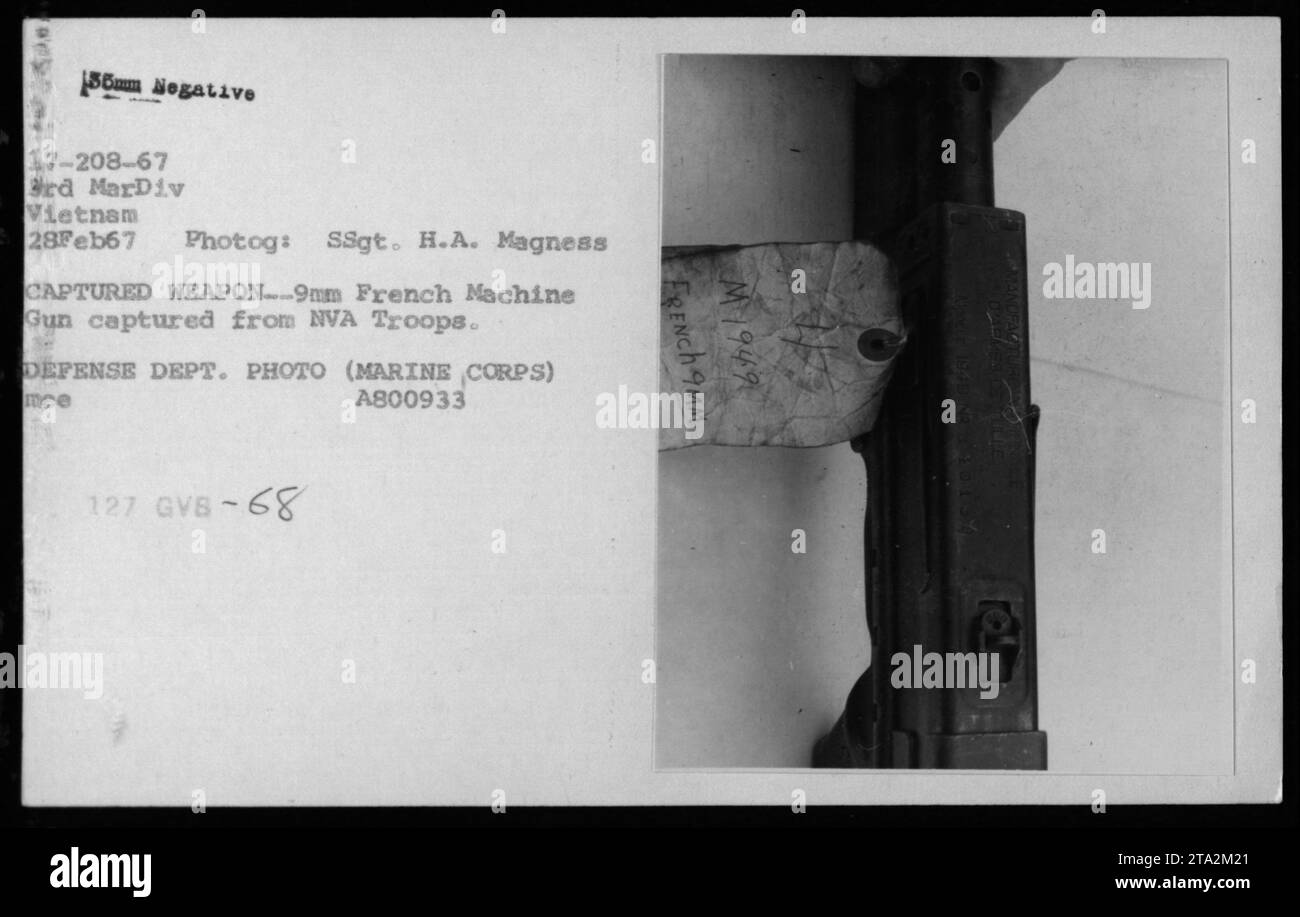 Marine Corps soldiers display a captured 9mm French machine gun, taken