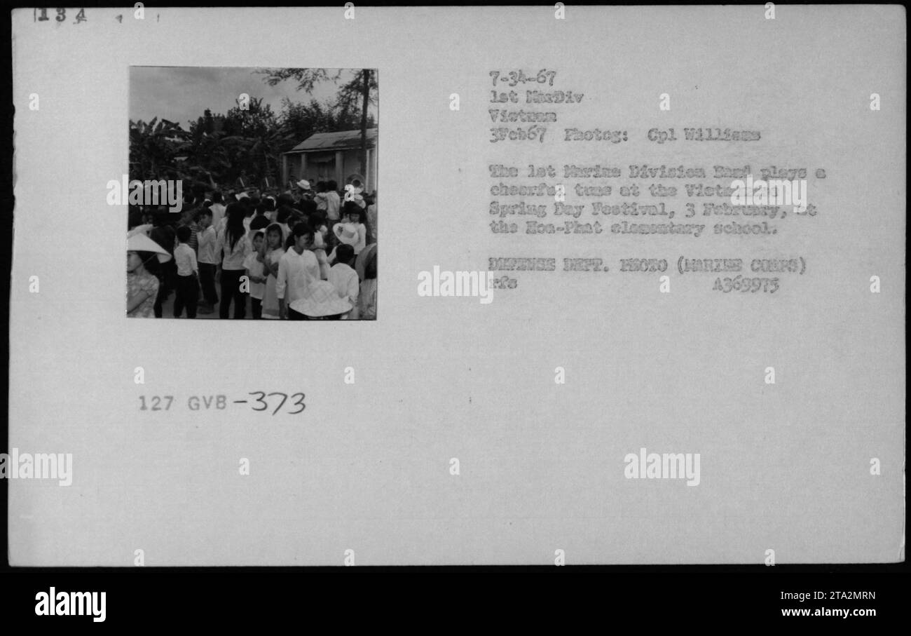 Vietnamese civilians participate in the Spring Day Festival held at Hoa-Phat elementary school on February 3, 1967. The event, captured by Cpl Williams on behalf of the 1st Division 3Fch67, shows the festivity and joy of the locals despite the ongoing conflict. Stock Photo