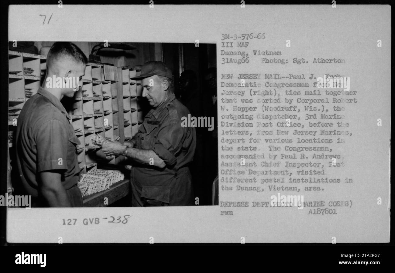 Democratic Congressman Paul J. Krebs from New Jersey ties mail together that was sorted by Corporal Robert W. Hopper of the 3rd Marine Division Post Office in Vietnam. The letters, sent by New Jersey Marines, are departing for various locations in the state. Congressman Krebs visited postal installations in the Danang area with Paul R. Andrews, Assistant Chief Inspector of the Post Office Department. Stock Photo