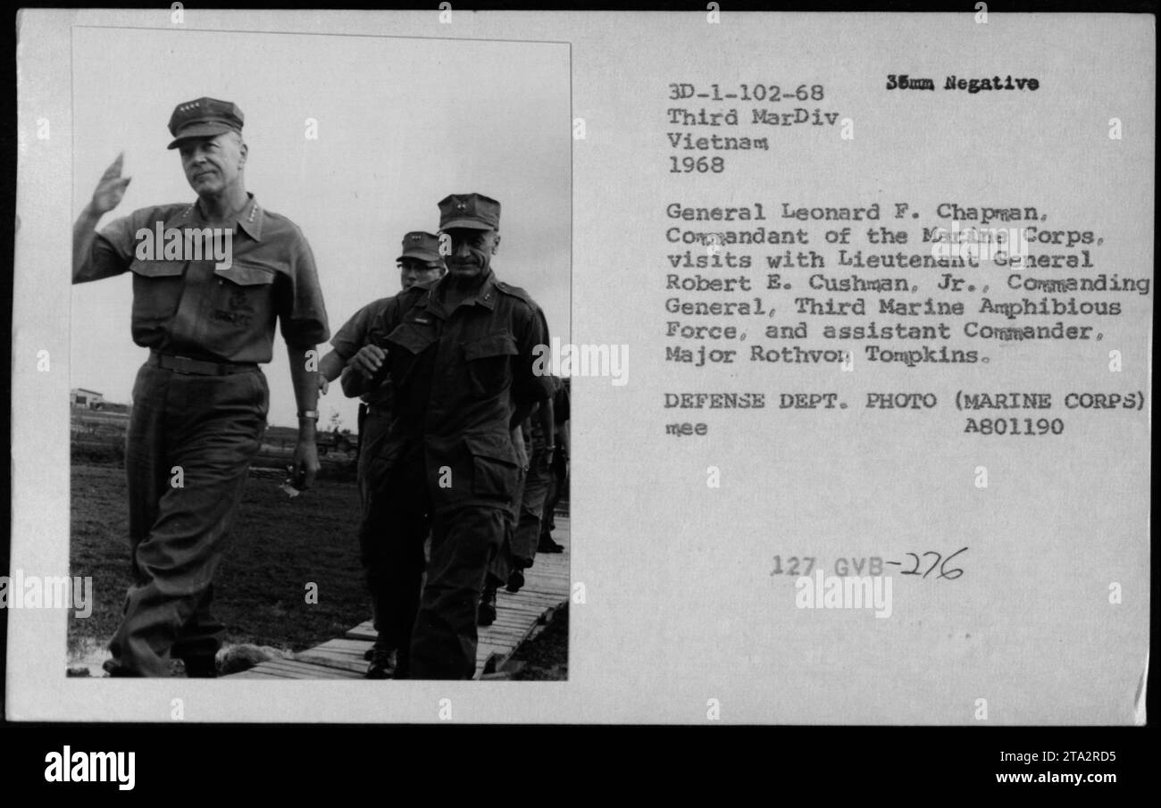Gen Leonard F Chapman visits Lt Gen Robert E Cushman Jr in Vietnam. Major Rothvon Tompkins is also present. Photo from 1968 Defense Dept. Photo (Marine Corps) with reference number 3D-1-102-68. Captured on a 35mm negative, the image shows high-ranking officers and officials discussing military activities during the Vietnam War. Stock Photo