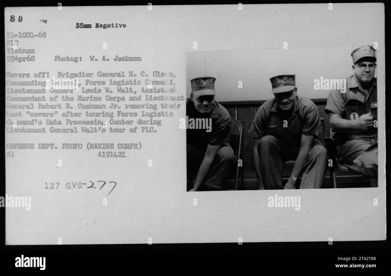 Lt Gen Lewis W Walt, Brigadier General H. C. Olson, and Lt Gen Robert E. Cushman Jr. remove their boot 'covers' after touring Force Logistic Command's Data Processing Center during Lt Gen Walt's visit to FLC Vietnam on April 29, 1968. DEFENSE DEPT. PHOTO (MARINE CORPS) d.1. A1914,21 127 GVB-277 Stock Photo