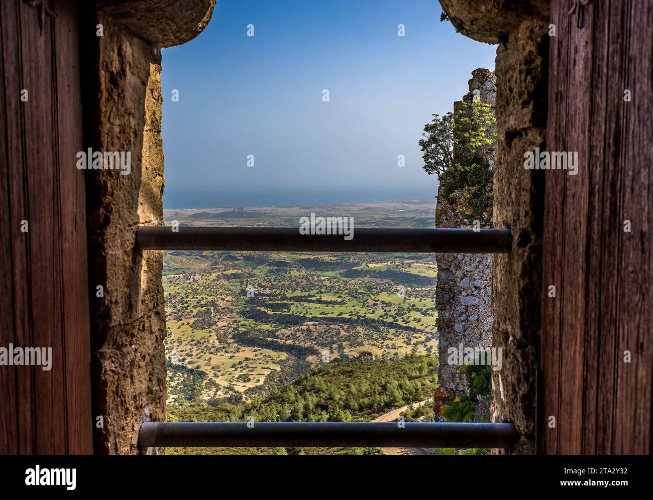 A twin bar window provides a panoramic view from Kantara Castle over the Mesaoria Plain in Northern Cyprus Stock Photo