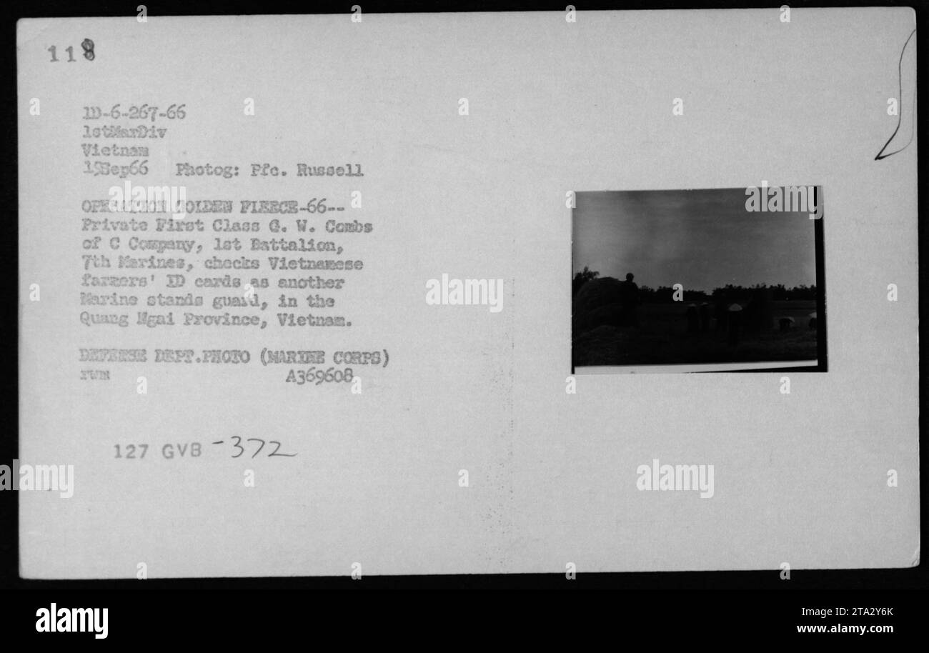 'Private First Class G. W. Combs of C Company, 1st Battalion, 7th Marines, verifies Vietnamese farmers' ID cards as another Marine stands guard in the Quang Ngai Province, Vietnam during Operation Golden Fleece-66. This photograph was taken on September 19, 1966, by Pfc. Russell and is a Defense Department photo (Marine Corps).' Stock Photo