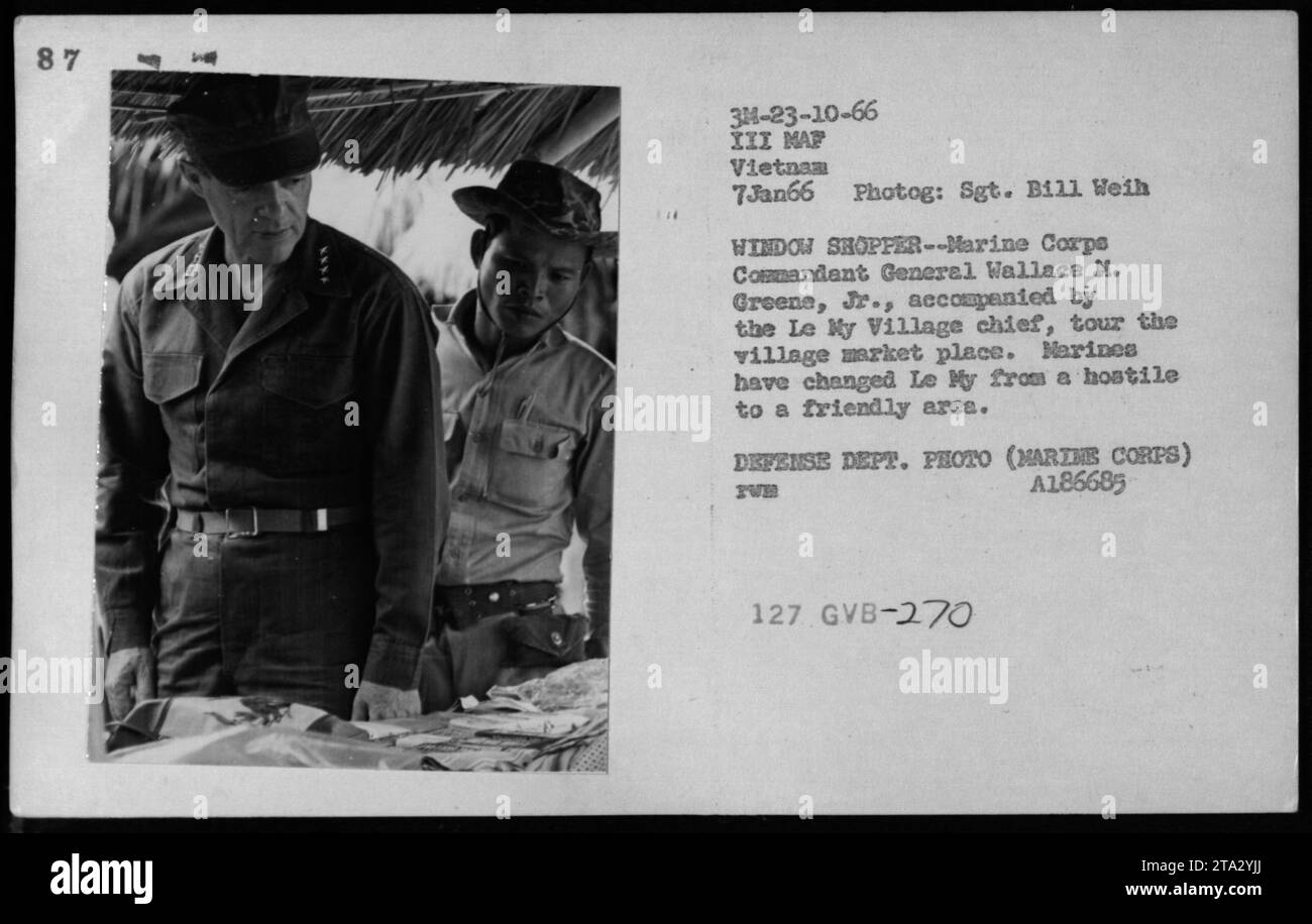 Marine Corps Commandant General Wallace M. Greene, Jr., and the Le My Village chief visit the village marketplace in Vietnam. This visit showcases the change of Marines transforming the once hostile area into a friendly one. This photograph was taken on January 7, 1966, during the American military activities in Vietnam. Stock Photo