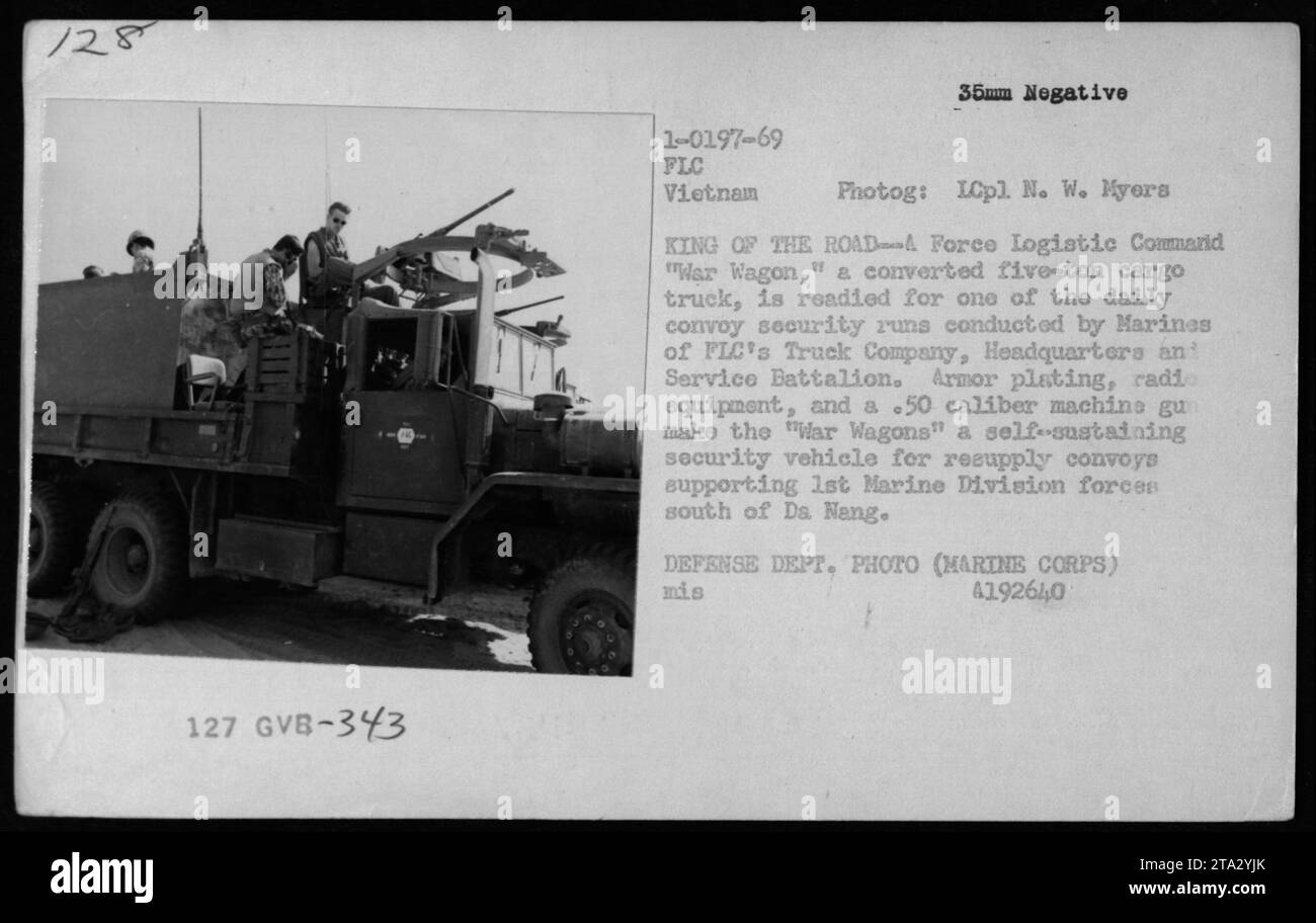 Marine Corps troops prepare a converted five-ton cargo truck called the 'War Wagon' for a daily convoy security run in Vietnam. The War Wagon is armored, equipped with radio gear, and features a .50 caliber machine gun. It serves as a self-sustaining security vehicle for resupply convoys supporting the 1st Marine Division near Da Nang. Stock Photo