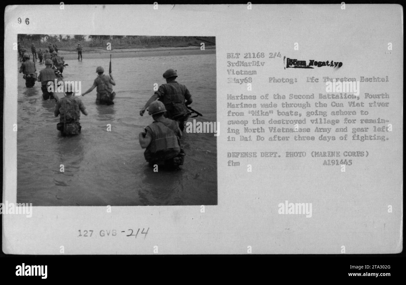 U.S. Marines from the Second Battalion, Fourth Marines, make their way through the Cua Viet river on May 3, 1968. The marines are moving ashore from 'Mike' boats to search for remaining North Vietnamese Army soldiers and equipment in the destroyed village of Dai Do after three days of fighting. This photo was taken by Ife Thurston Bachtel of the Defense Department. Stock Photo
