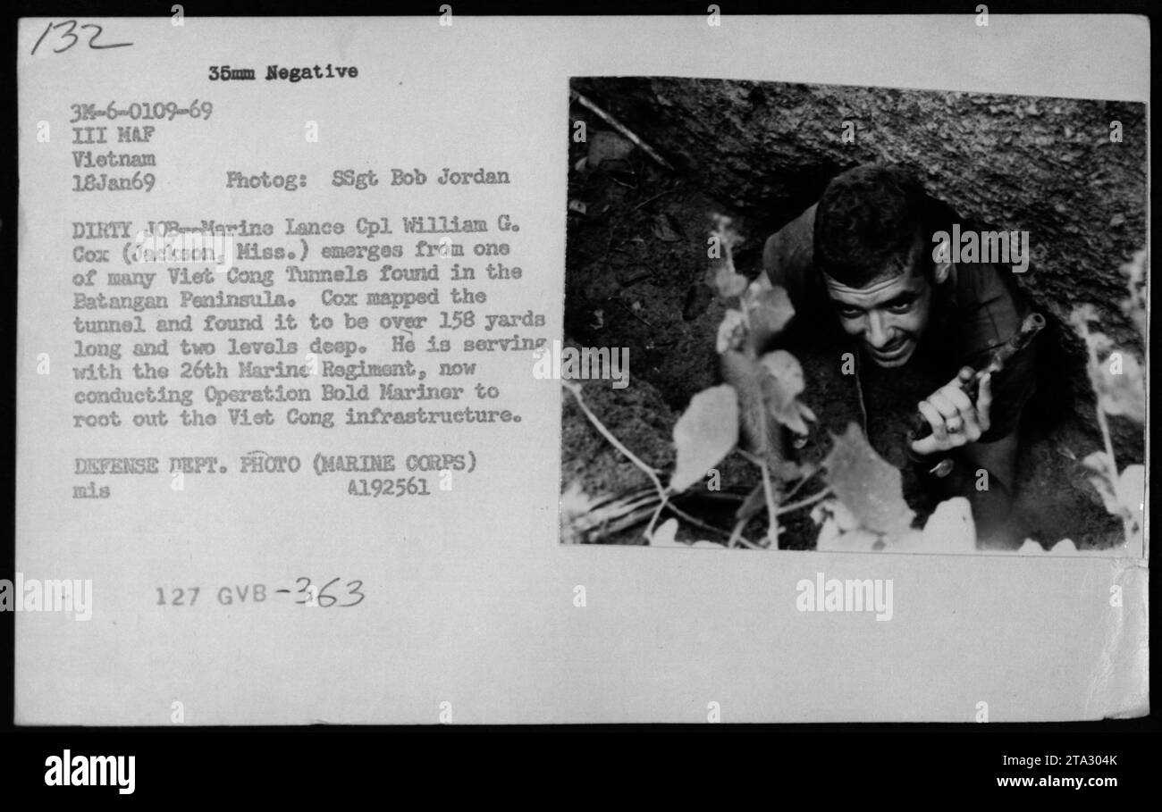 Marine Lance Cpl. William G. Cox emerges from one of the Viet Cong Tunnels found in the Batangan Peninsula during the Vietnam War. The tunnel was approximately 158 yards long and had two levels. Cox, who was serving with the 26th Marine Regiment, was part of Operation Bold Marinor aimed at rooting out the Viet Cong infrastructure. Stock Photo