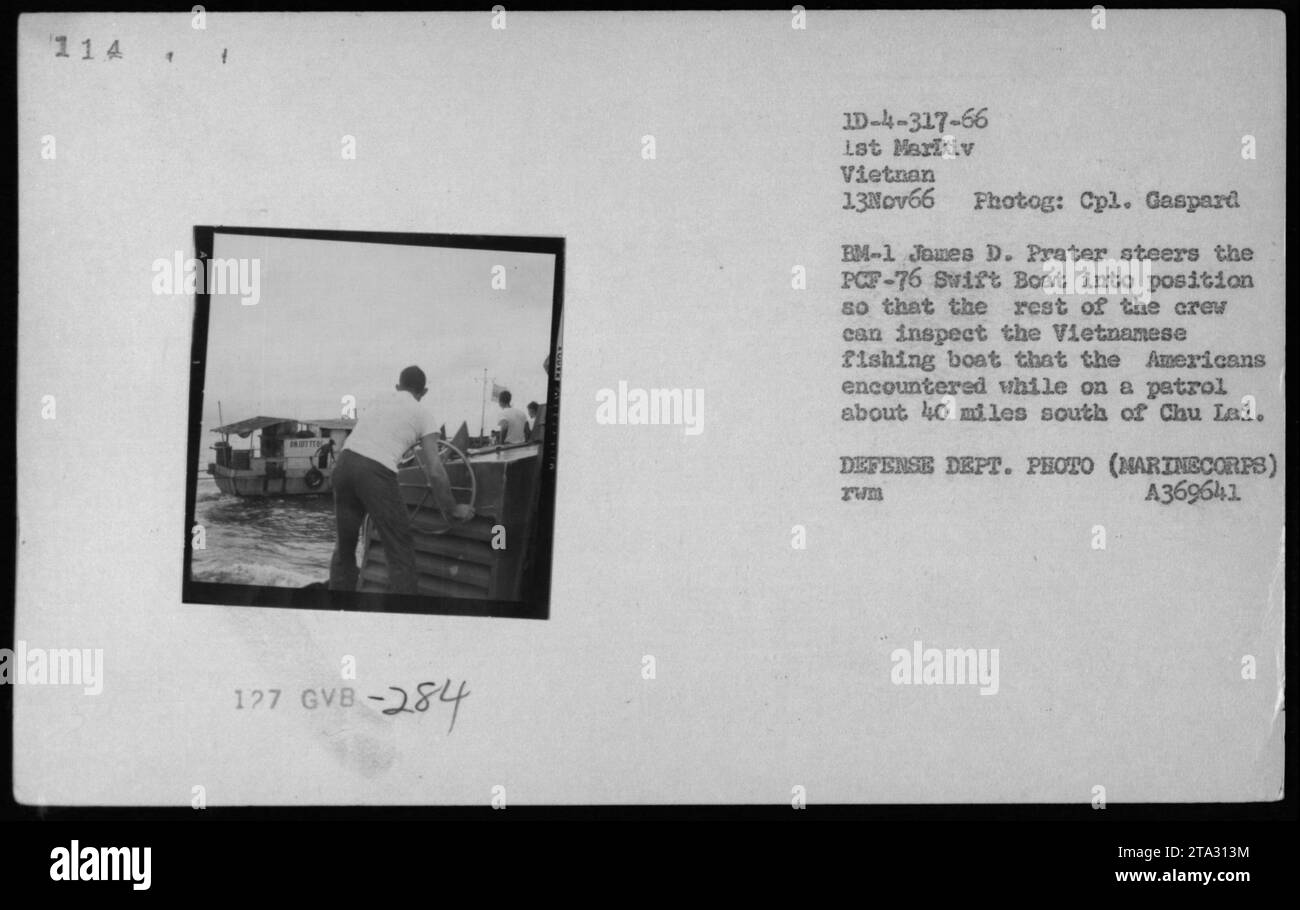 Marine Corps EM-1 James D. Prater steering PCF-76 Swift Boat into position for crew inspection of a Vietnamese fishing boat encountered during a patrol approximately 40 miles south of Chu Lai. Photographed by Cpl. Gaspard on November 13, 1966. (Defense Department Photo, Marine Corps, A369641) Stock Photo