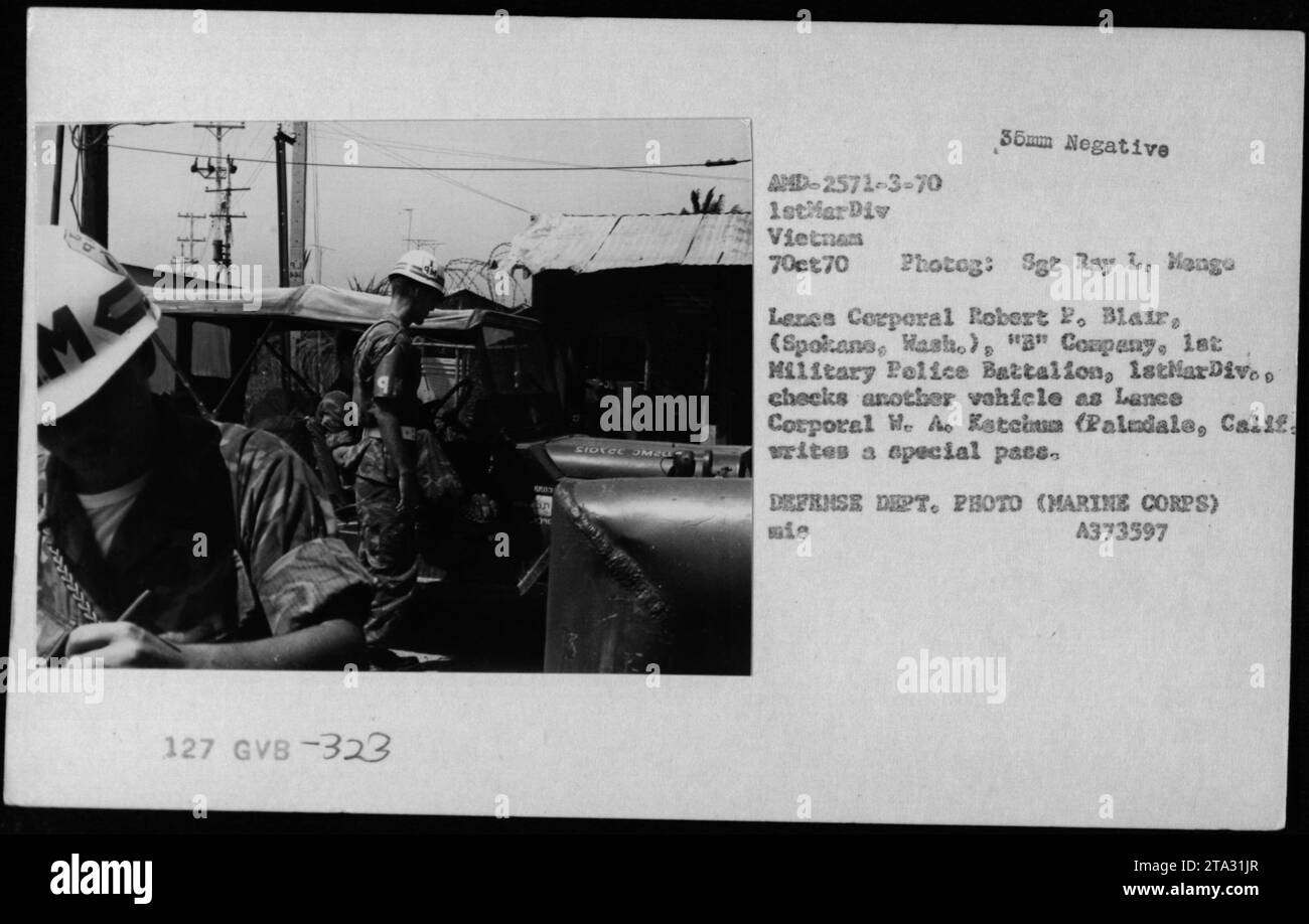 Security measures during the Vietnam War- On October 7, 1970, Sergeant Ray L and Corporal Robert P. Blair from 'B' Company, 1st Military Police Battalion, 1st Marine Division, check a vehicle while Lance Corporal We Ao Ketchum writes a special pace. This image showcases the diligent security efforts carried out by military personnel during the war. Stock Photo