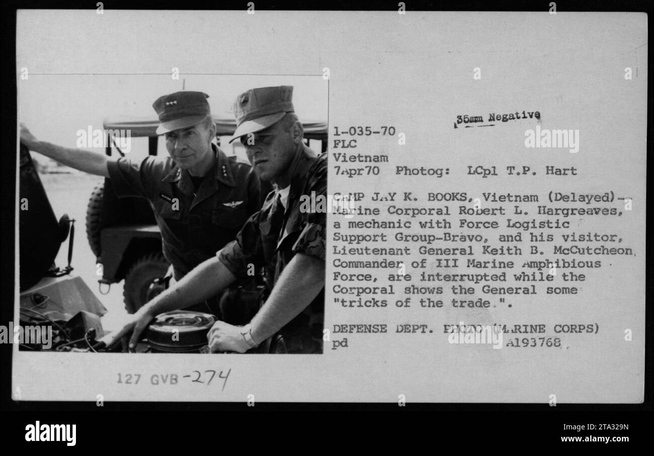Marine Corporal Robert L. Hargreaves, a mechanic with Force Logistic Support Group-Bravo, is seen showing Lieutenant General Keith B. McCutcheon, Commander of III Marine Amphibious Force, some 'tricks of the trade' at Camp Jay K. Books in Vietnam. Photog: LCpl T.P. Hart, April 7, 1970. DEFENSE DEPT. PHOTO (M..RINE CORPS) pd A193768. Stock Photo