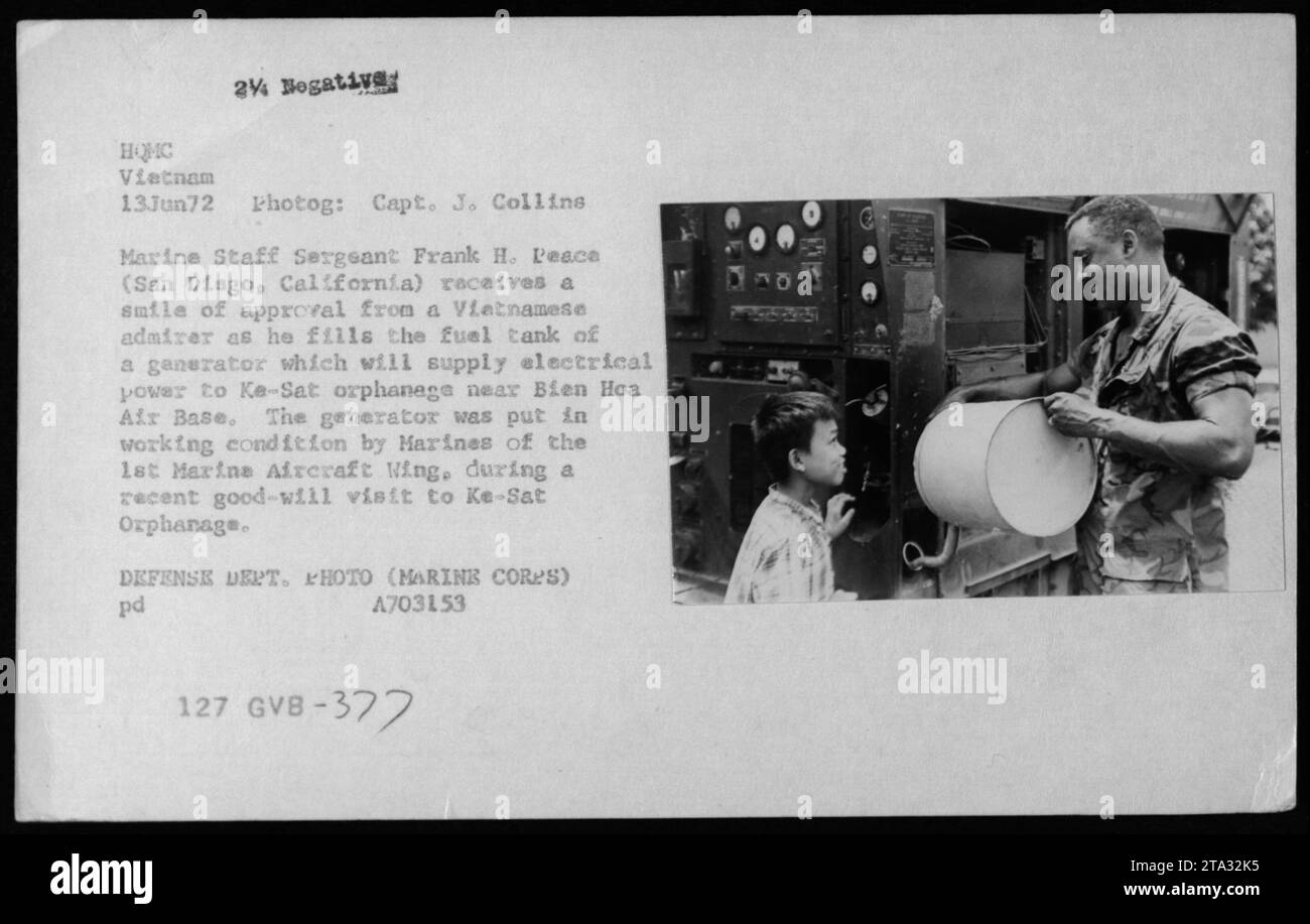 Marine Staff Sergeant Frank H. Peace of San Diago, California receives a smile of approval from a Vietnamese admirer as he fills the fuel tank of a generator at Ke-Sat orphanage near Bien Hoa Air Base. The generator was repaired by Marines of the 1st Marine Aircraft Wing during a good-will visit to the orphanage. Stock Photo