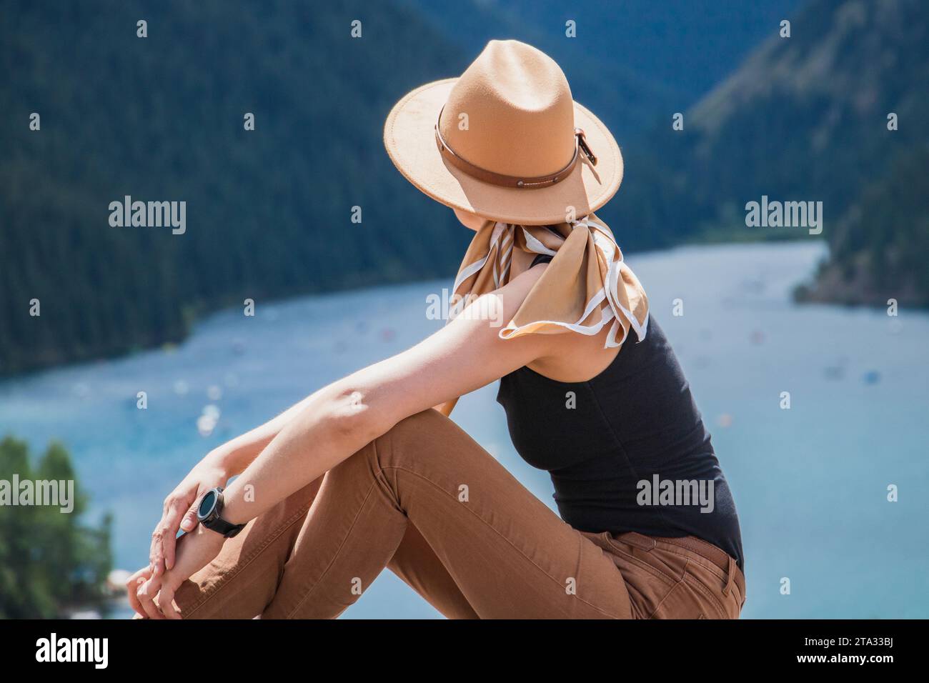 Young woman look on Kolsay mountain lake in Kolsai Koldery gorge near Almaty, nature of Kazakhstan National Park, Central Asia Stock Photo