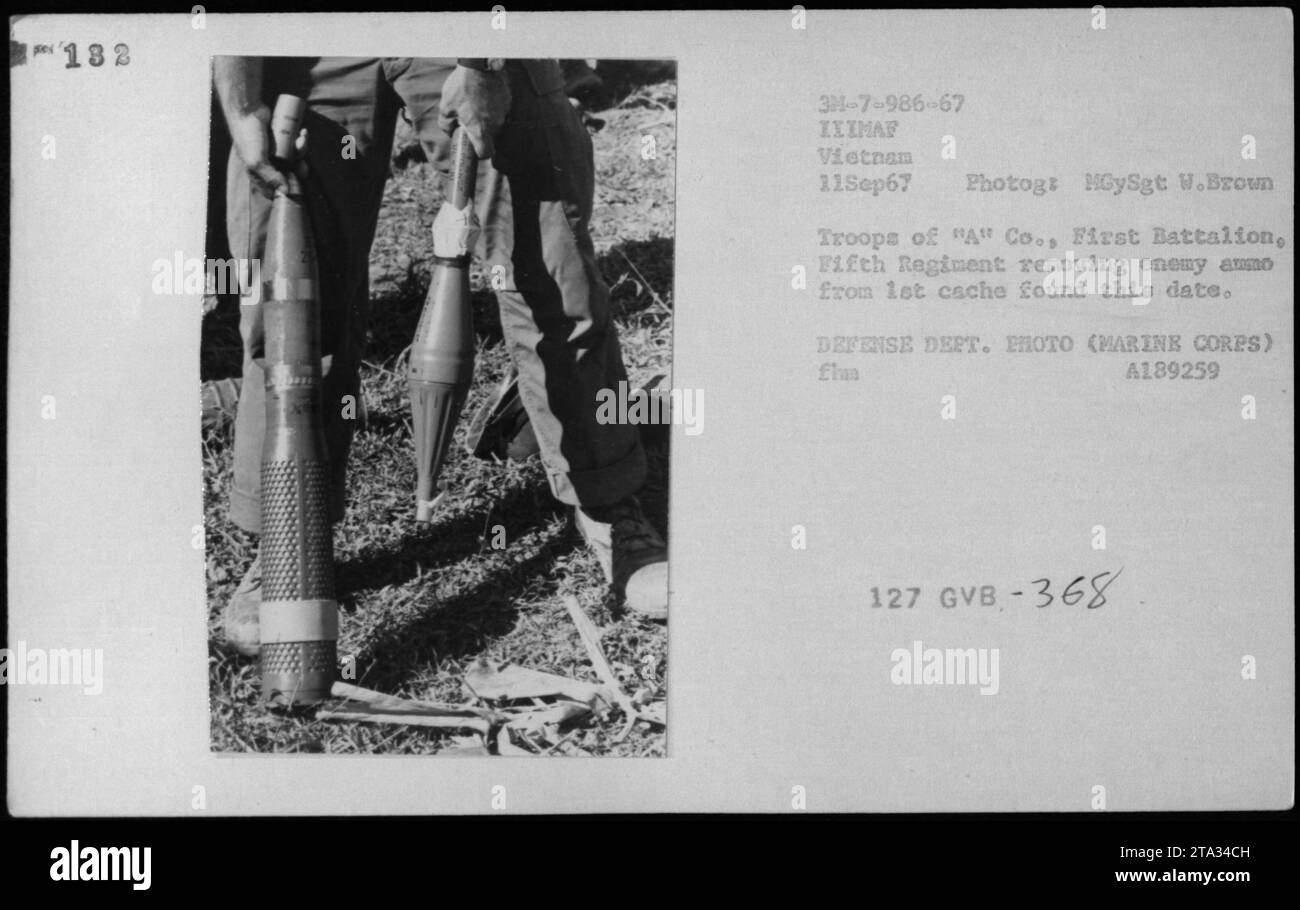 Vietnamese soldiers uncover and remove enemy ammunition from a cache found on September 11, 1967 during the Vietnam War. This photograph, taken by HGySgt W. Brown, captures troops from 'A' Company, First Battalion, Fifth Regiment as they handle the captured items. This is an official Defense Department photo. Stock Photo