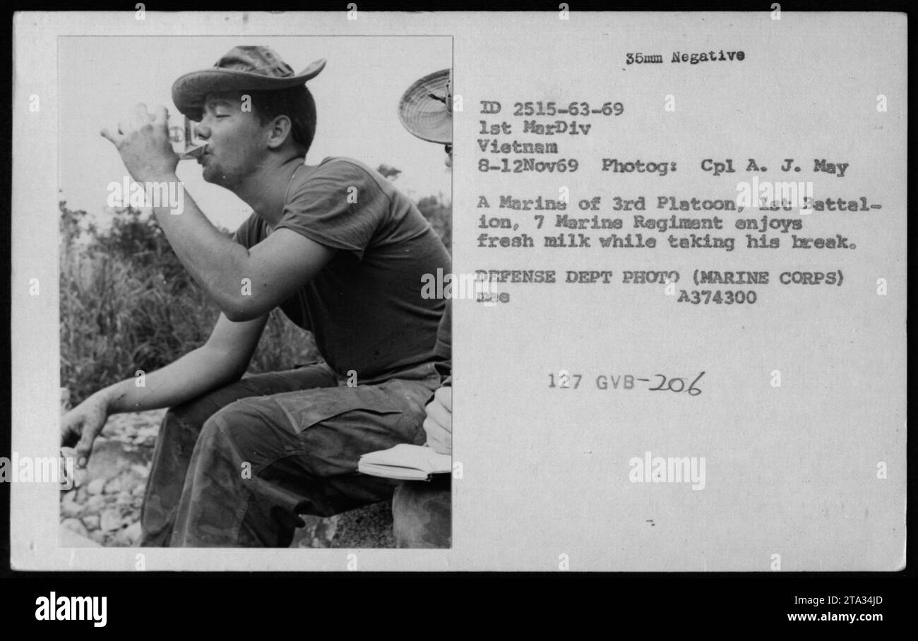 Marine of 1st Battalion, 7th Marine Regiment, from the 3rd Platoon, 1st Marine Division, enjoys fresh milk during a break on November 8, 1969 in Vietnam. The photograph was taken by Cpl A. J. May and is part of the Defense Department's collection. (Caption: Marine takes a break and enjoys fresh milk during his service in Vietnam.) Stock Photo