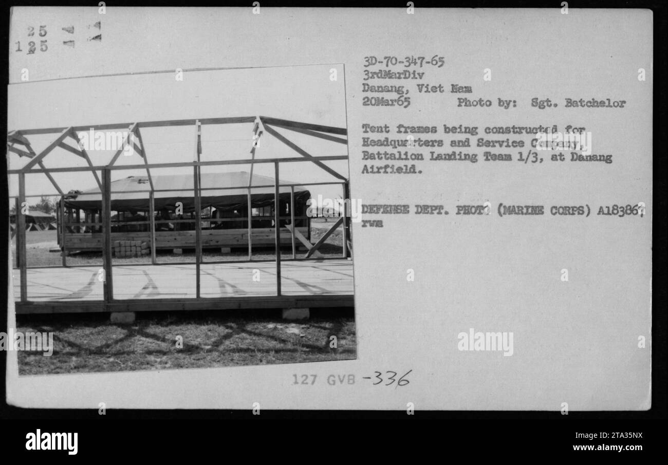 Soldiers constructing tent frames for Headquarters and Service Company, Battalion Landing Team 1/3, at Danang Airfield. The photo was taken on March 20, 1965. The image is from the collection of American military activities during the Vietnam War and was taken by Sergeant Batchelor. Stock Photo