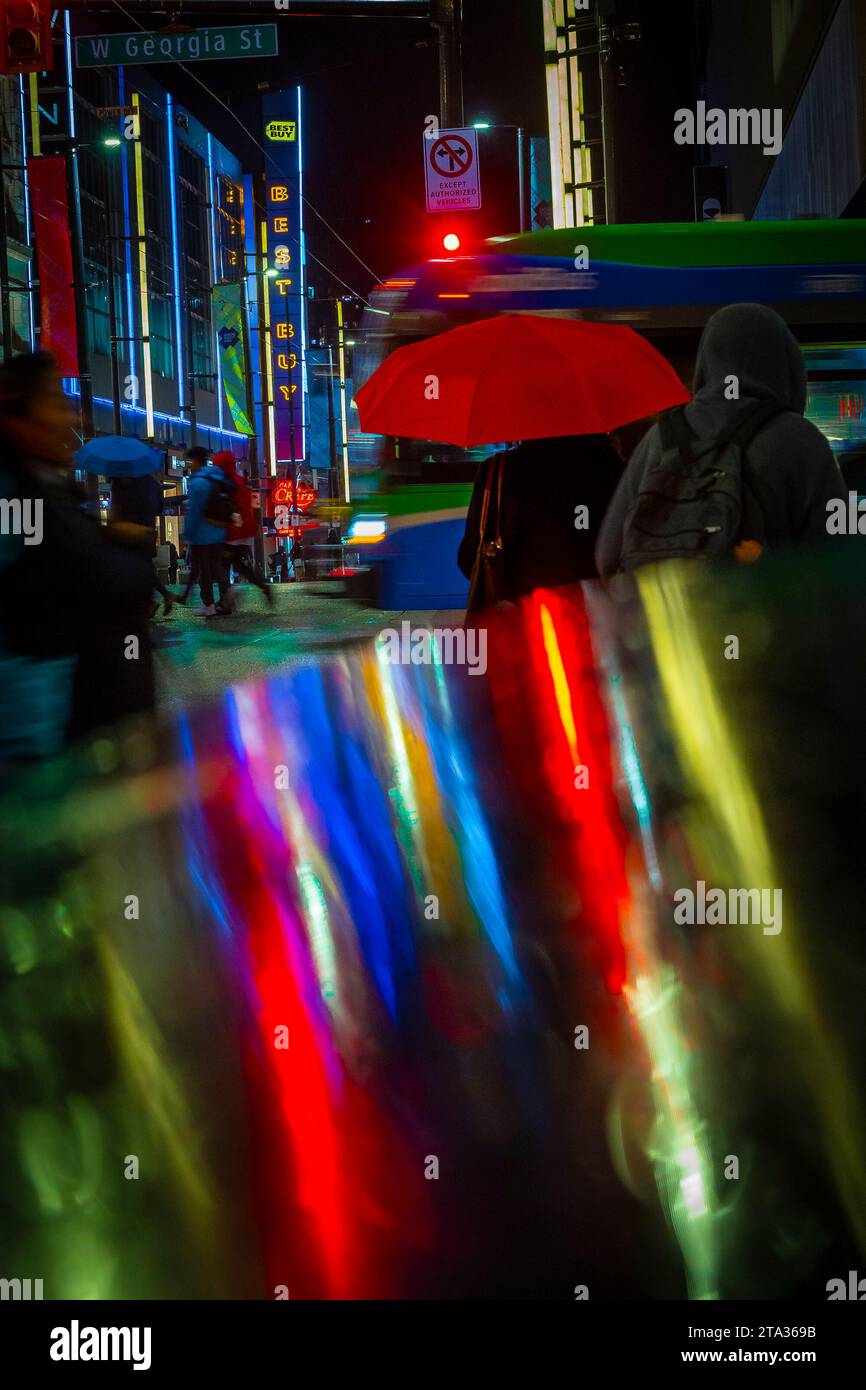 Rainy night, intersection, Granville and Georgia, downtown, Vancouver, British Columbia, Canada Stock Photo