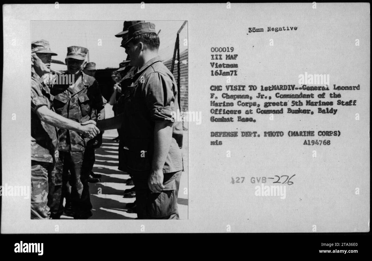 Gen Leonard F Chapman, Commandant of the Marine Corps, greets staff officers of the 5th Marines at Command Bunker, Baldy Gombat Base, during his visit on January 16, 1971. This photograph captures the interaction between high-ranking officials and highlights the active involvement of the military during the Vietnam War. Stock Photo