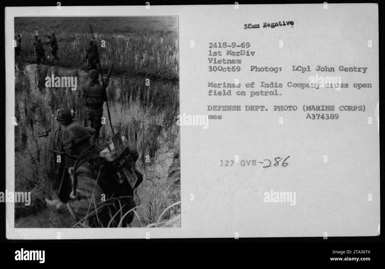 Marines from India Company conducting patrols in Vietnam - October 30, 1969. The photo shows them crossing an open field, as captured by LCpl John Gentry. Image credit: DEFENSE DEPT. PHOTO (MARINE CORPS) A374389. Stock Photo