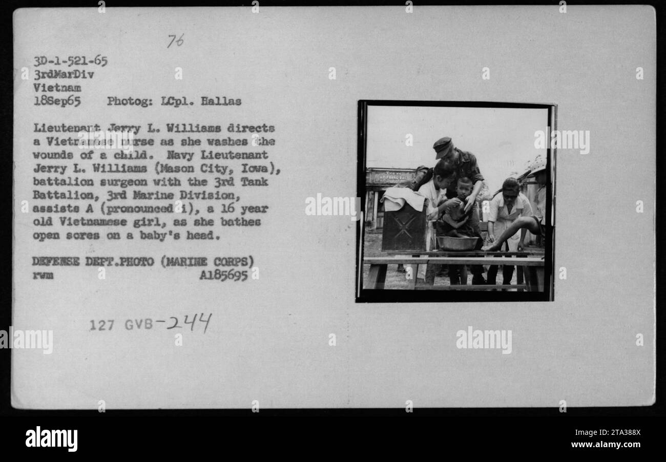 Vietnamese nurse washes wounds of child as Lieutenant Jerry L. Williams