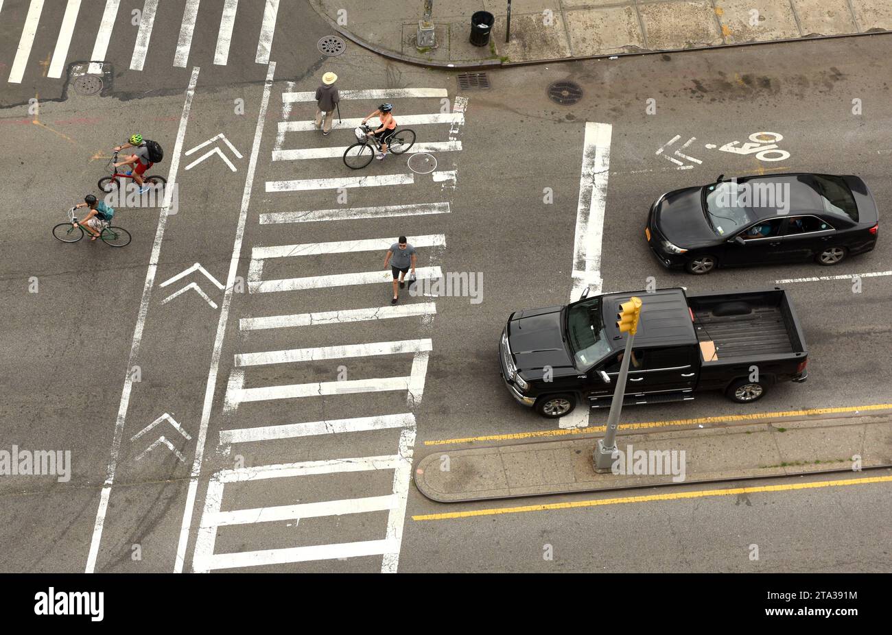 New York, USA - June 9, 2018: People walking on zebra crossings in New York. Top view at the intersection with peope on zebra crossings. Stock Photo