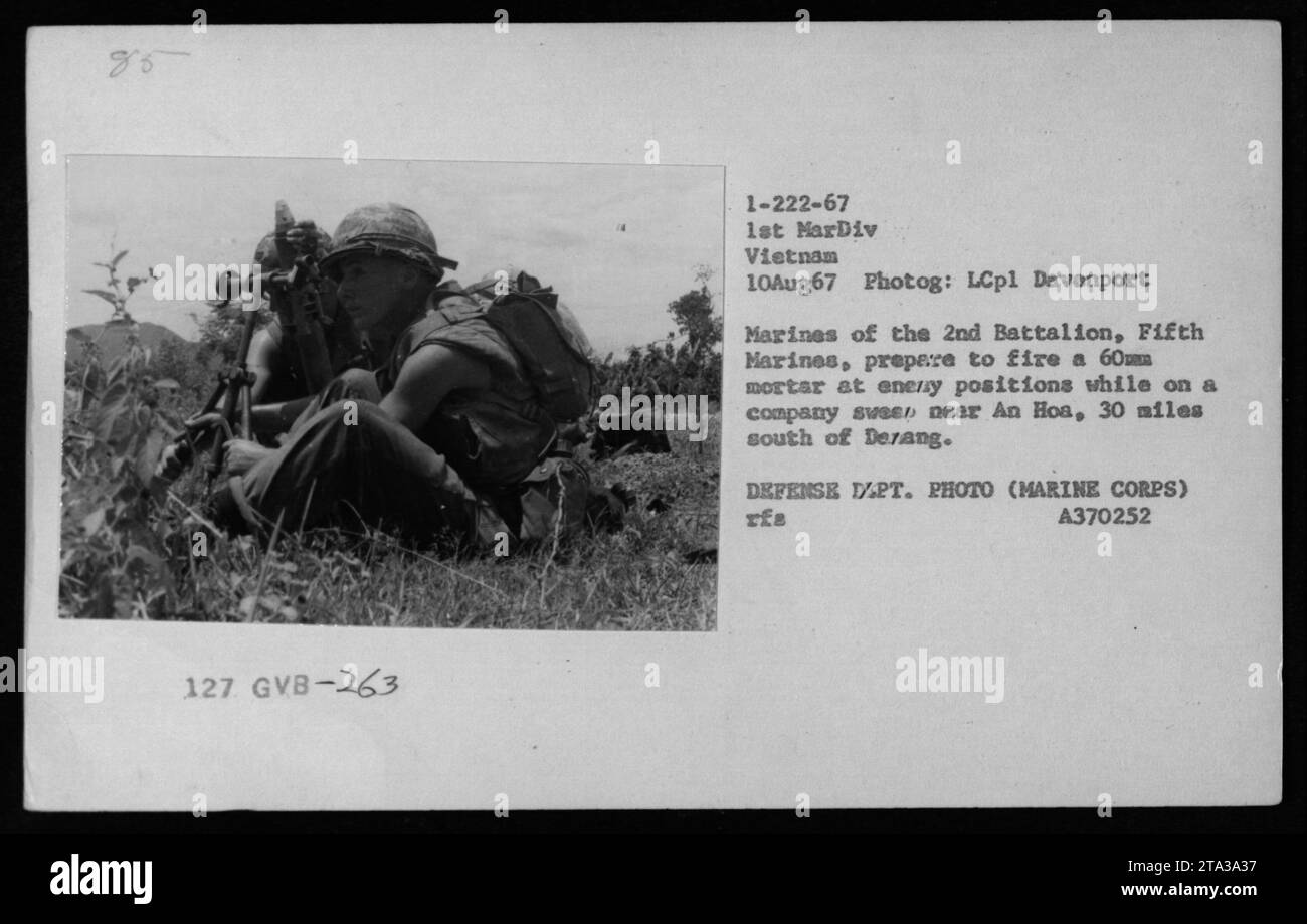 Marines from the 2nd Battalion, Fifth Marines, are seen in this photograph preparing to fire a 60mm mortar at enemy positions near An Hoa, Vietnam on August 10, 1967. This image was taken by LCpl Davenport and is part of a collection showcasing American military activities during the Vietnam War. Stock Photo