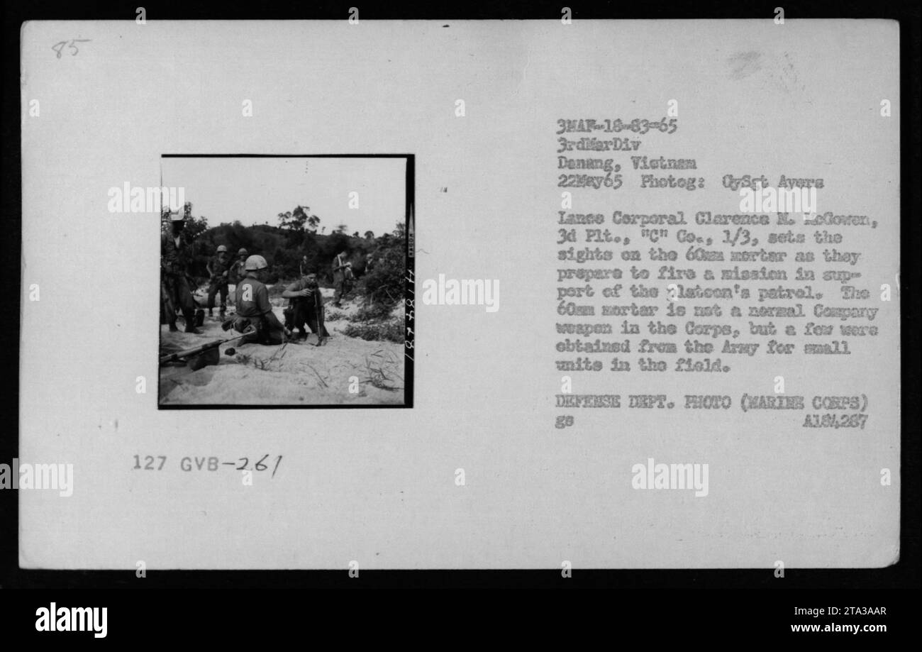 May 22, 1965 - Lance Corporal Clarence M. McGowan of 3rd Platoon, 'C' Company, 1/3 sets the sights on a 60mm mortar as they prepare to fire a mission in support of the platoon's patrol in Dening, Vietnam. The 60mm mortar was not a standard weapon in the Marine Corps but was obtained from the Army for small units in the field. Photograph by Sgt Ayers, Defense Department. Stock Photo