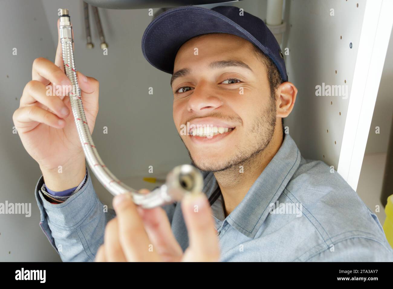 male plumber fixing sink pipe Stock Photo