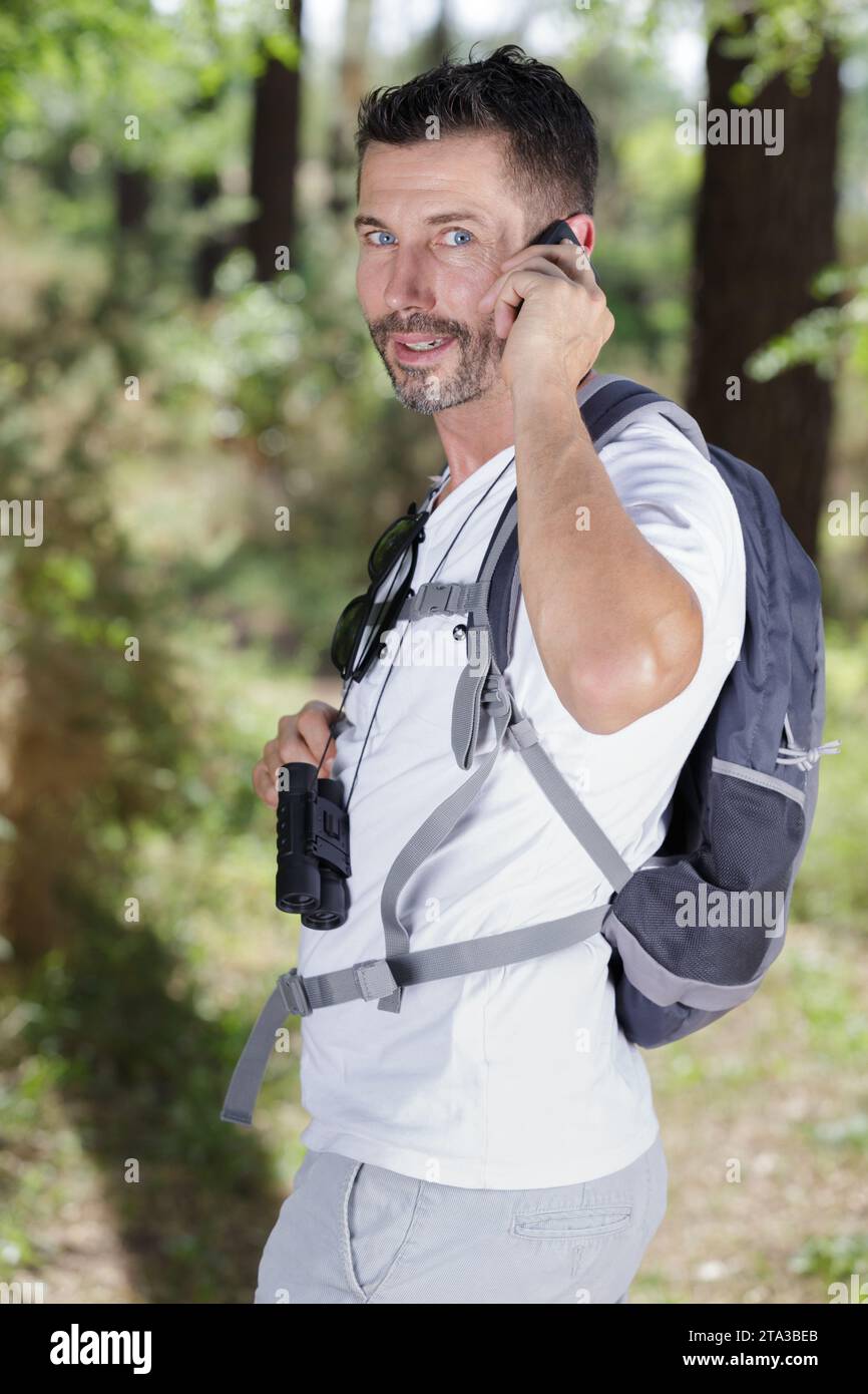 bird observer using his cellphone Stock Photo