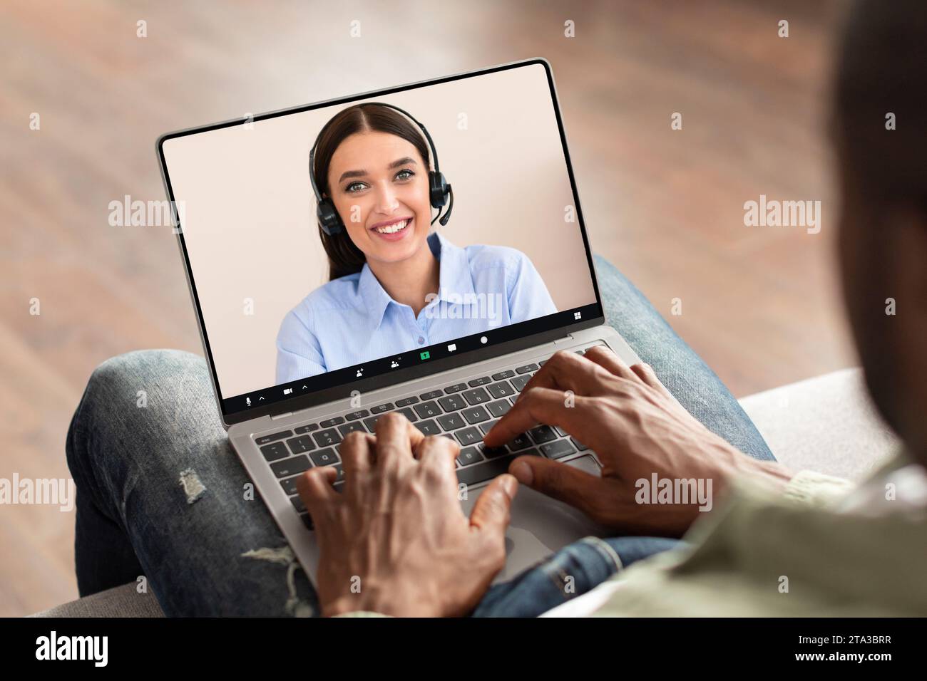 Black man using modern laptop with telecommunication screen at home Stock Photo