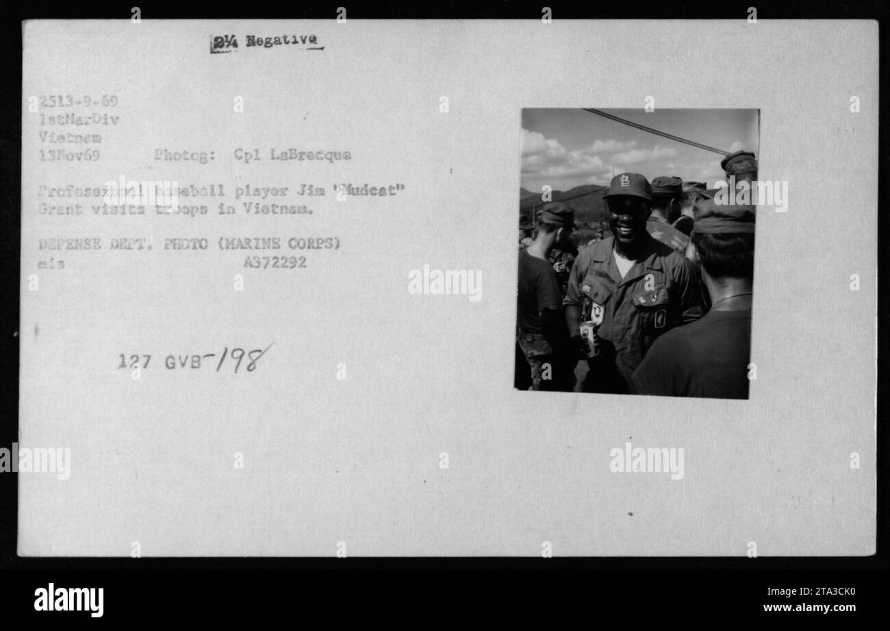Professional baseball player Jim 'Mudcat' Grant visits troops in Vietnam on November 13, 1969. He is seen entertaining Marines from the 1st Marine Division, spreading joy and boosting morale. This image was taken by Cpl LaBrecqua and is part of a collection of photographs documenting American military activities during the Vietnam War. Stock Photo