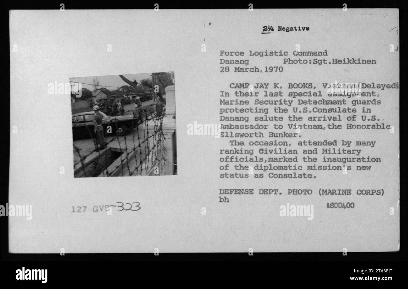 Marine Security Detachment guards in Danang salute the arrival of U.S. Ambassador Ellsworth Bunker at the U.S. Consulate on March 28, 1970. The event celebrated the Consulate's new status as a diplomatic mission. The guards were responsible for providing security and protection to the Consulate during the Vietnam War. This photo was taken by Sgt. Heikkinen. Stock Photo