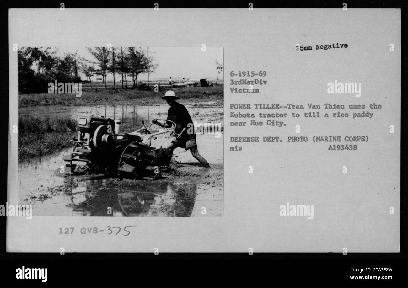 Vietnamese civilian Tran Van Thieu operates a Kubota tractor to cultivate a rice field near Hue City during the Vietnam War. The image is from 1969 and was captured by the Defense Department photographer, assigned to the 3rd Marine Division. Stock Photo