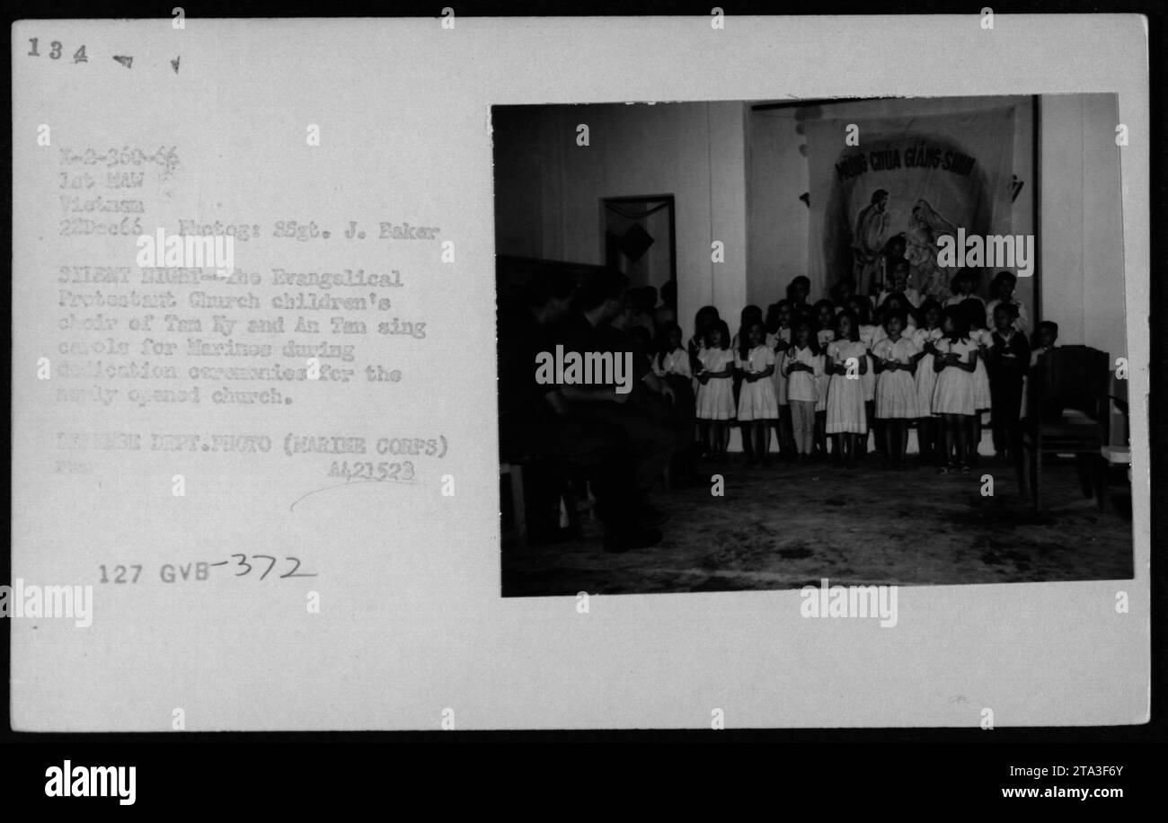 Vietnamese children in the Evangelical Protestant Church choir of Tan Ky and An Tam sing carols for Marines during the dedication ceremonies for the newly opened church. This photo was taken on December 22, 1966, as part of documenting American military activities during the Vietnam War. Stock Photo
