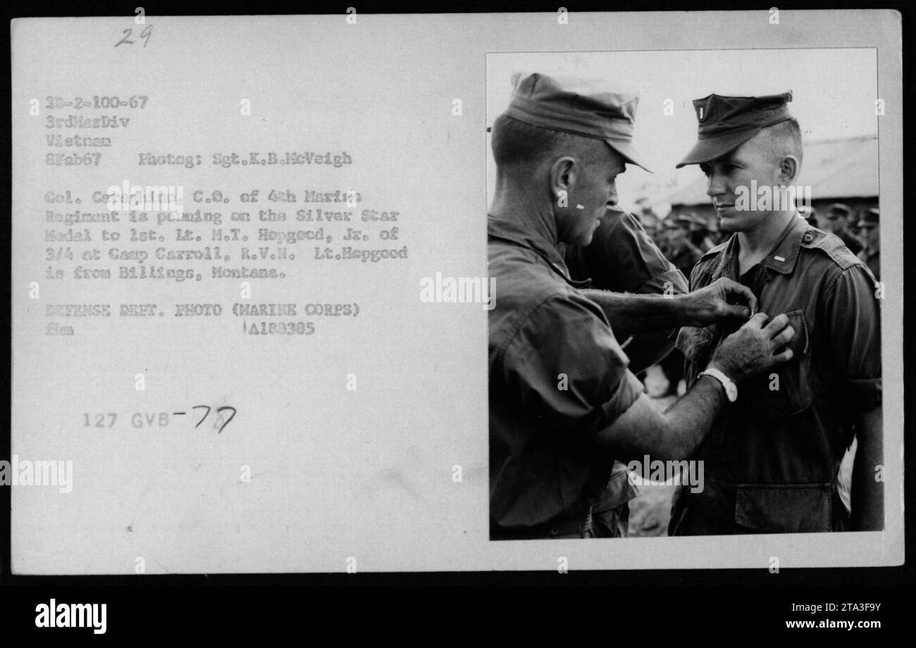 'Col. Cereghino, the commanding officer of the 4th Marine Regiment, is seen awarding the Silver Star Medal to 2nd Lt. M.T. Hopgood of the 3rd Battalion, 4th Marines at Camp Carroll, Vietnam. Lt. Hopgood hails from Billings, Montana. This photograph was taken on February 8, 1967, during military ceremonies attended by Hubert Humphrey.' Stock Photo