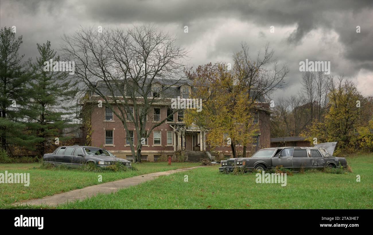 Limousines left on front grounds of the abandoned Tuberculosis Hospital (1908) of the Indiana State Sanatorium in Rockville, Indiana Stock Photo