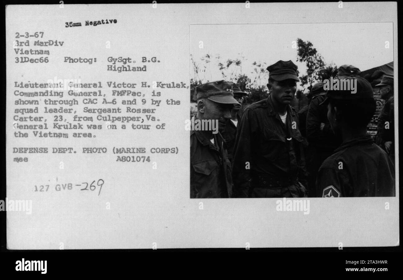 Lieutenant General Victor H. Krulak, Commanding General, FMFPаc, is shown touring the Vietnam area in December 1966. In the image, Sergeant Rosser Carter, squad leader, guides General Krulak through CAC A-6 and 9. The photograph was taken by GySgt. B.G. Highland and is labeled as Defense Dept. PHOTO (MARINE CORPS) A801074 127. Stock Photo