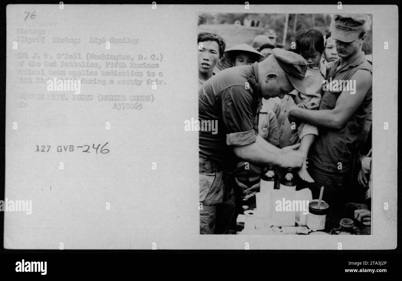 A medical team from the 2nd Battalion, Fifth Marines attending a county fair in Minh Binh, Vietnam on April 17, 1967. The team treated a Minh Binh child, applying medication to them. The photograph was taken by LCpl Smedley MN J.W. O'Dell of Washington, D.C. Defense Dept. Photo (Marine Corps) ref A370065 127 GVB-246. Stock Photo