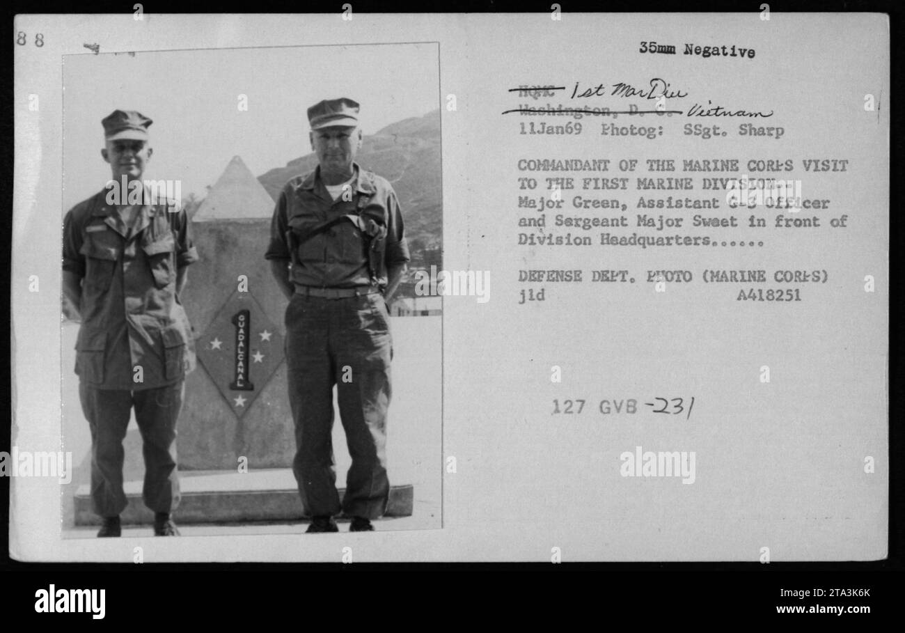 Caption: Major Green, Assistant G-3 Officer, and Sergeant Major Sweet in front of Division Headquarters during the visit of the Commandant of the Marine Corps to the First Marine Division in Washington, D.C., Vietnam on January 11, 1969. This photograph is part of the Defense Department's collection and was taken by SSgt. Sharp. Stock Photo